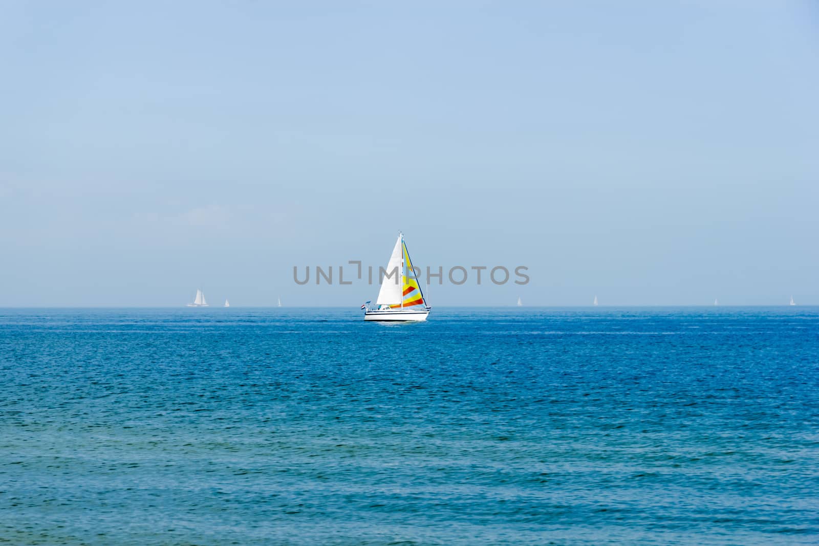 Seascape with sailboat the background of the blue sky. by Tetyana