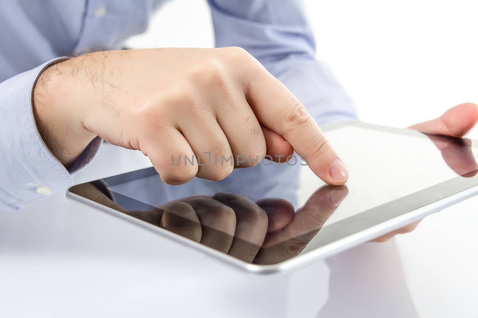 Closeup of man fingers touching screen on modern digital electronic tablet