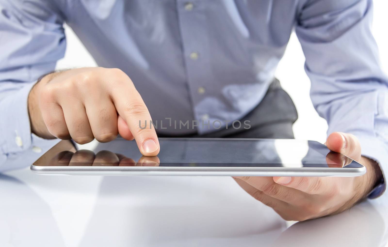 Man fingers touching screen on digital tablet by doble.d