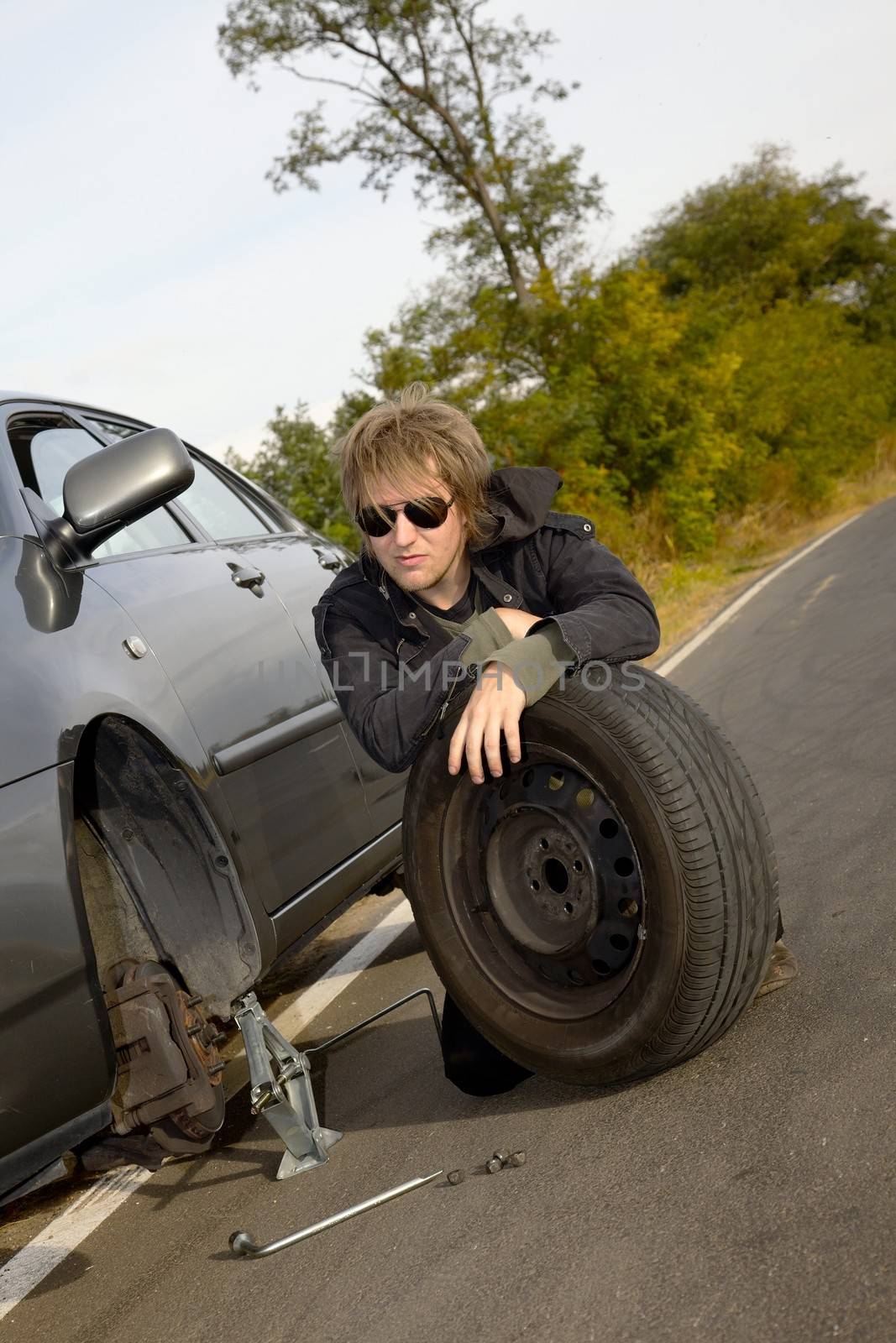 Man changing tires on car
