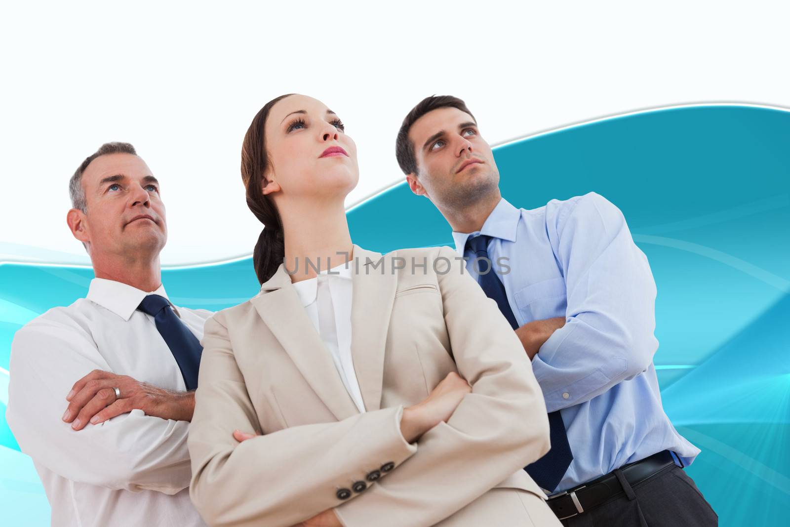 Composite image of serious work team posing together looking away