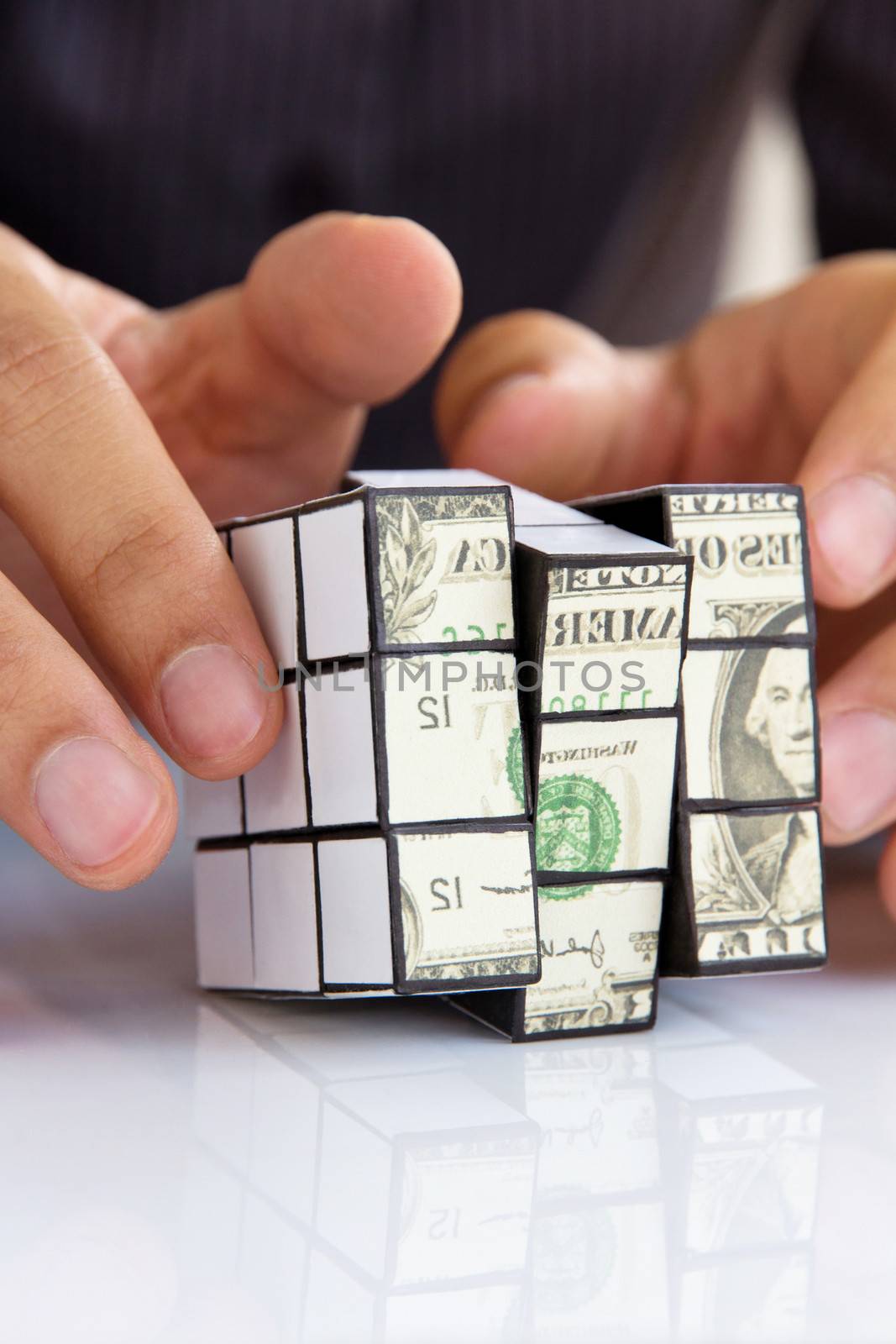 business man hand holding a rubik's cube,money concept