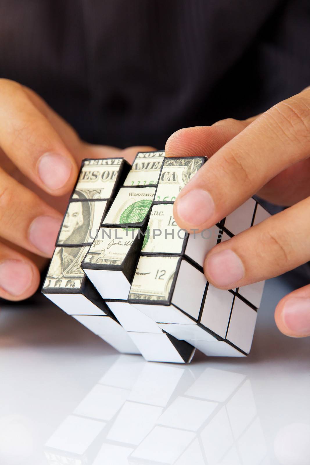 business man hand holding a rubik's cube,money concept