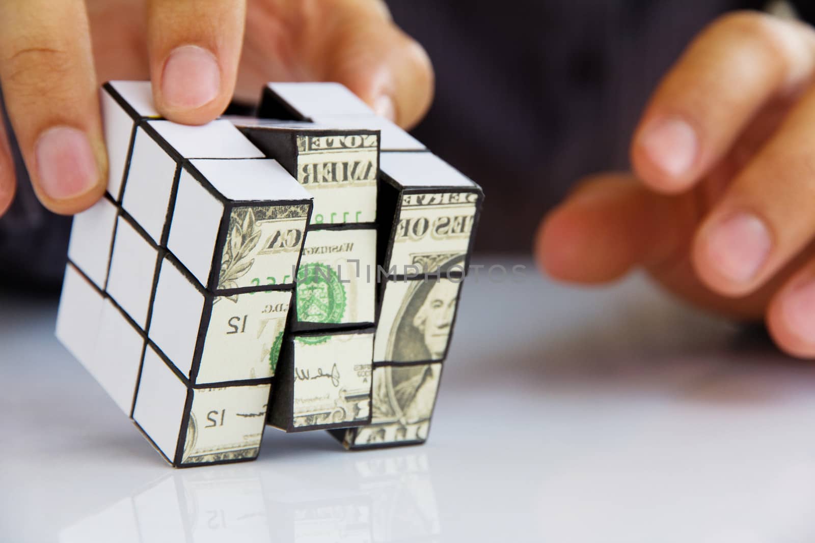 business man hand holding a rubik's cube,money concept