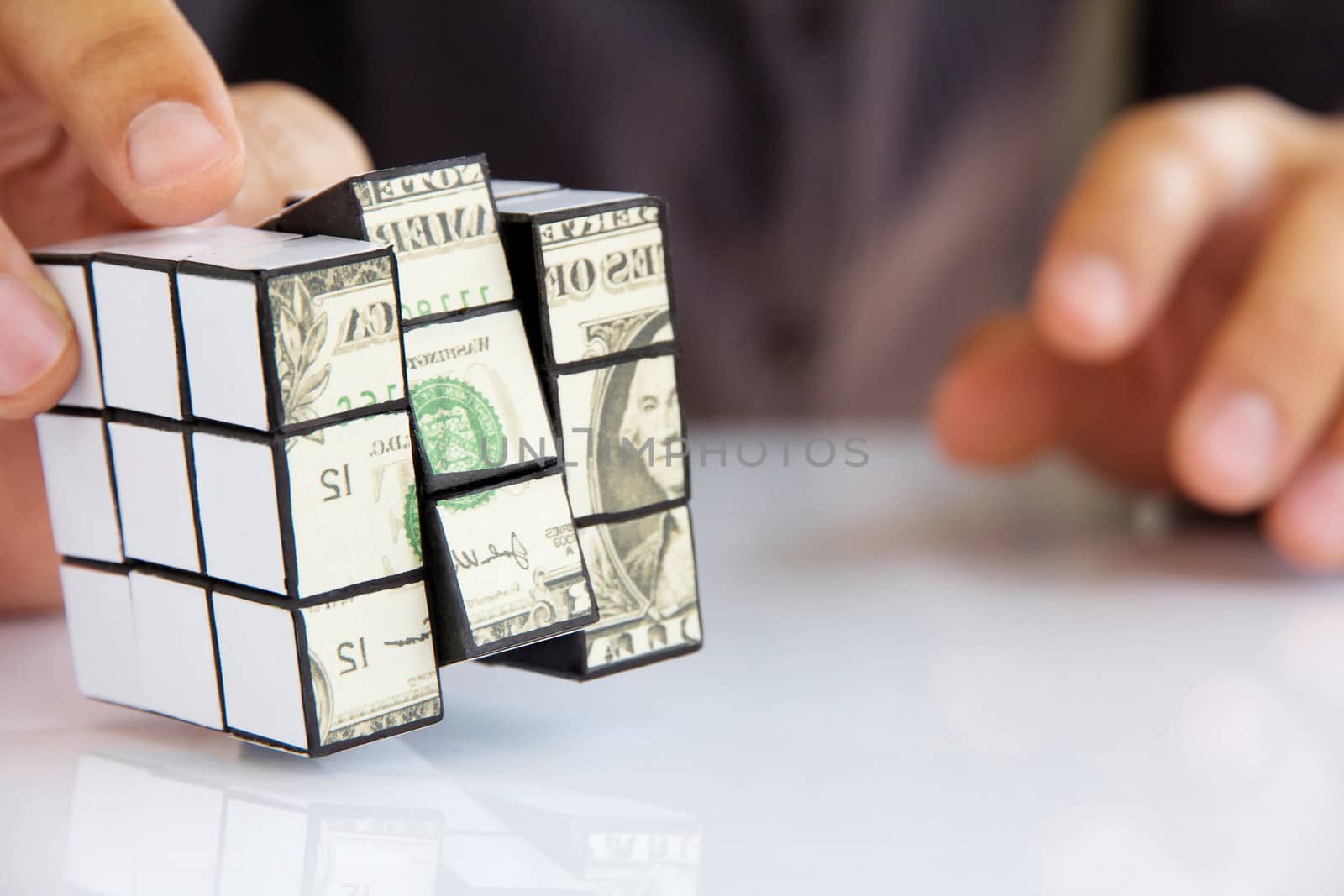 business man hand holding a rubik's cube,money concept