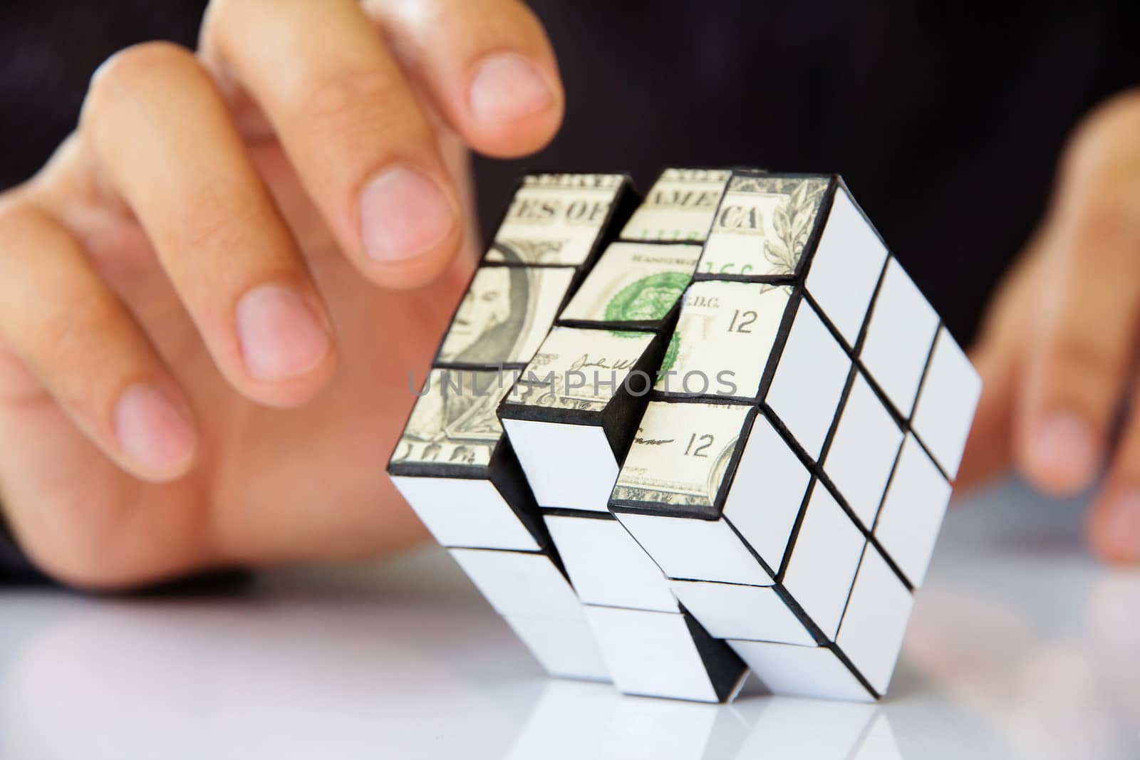 business man hand holding a rubik's cube,money concept