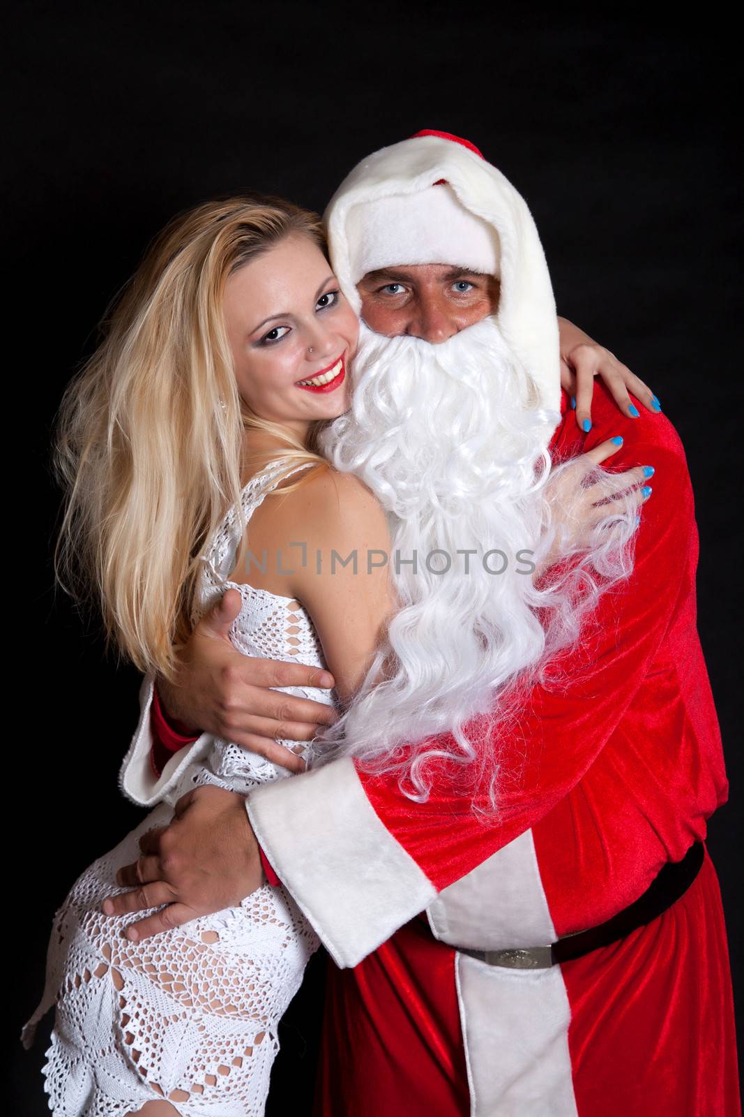 Man Santa Claus hugging a woman angel on a black background