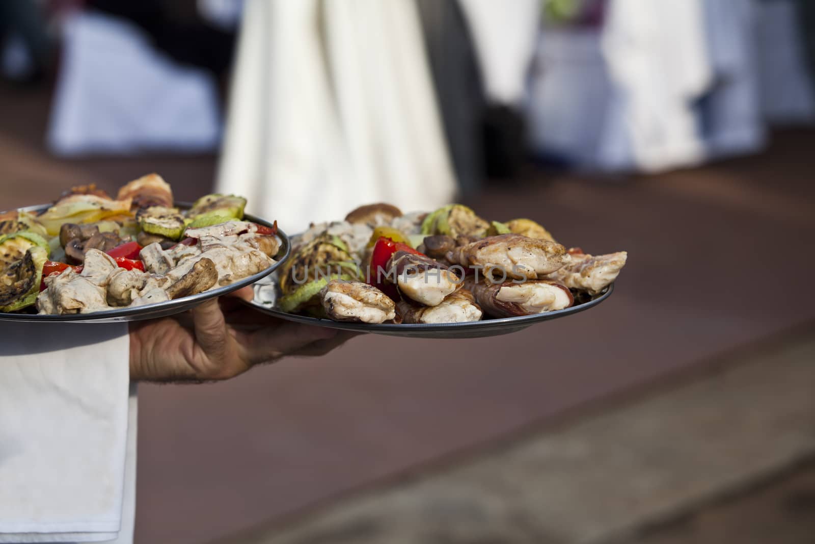 Waiter carrying plates of food