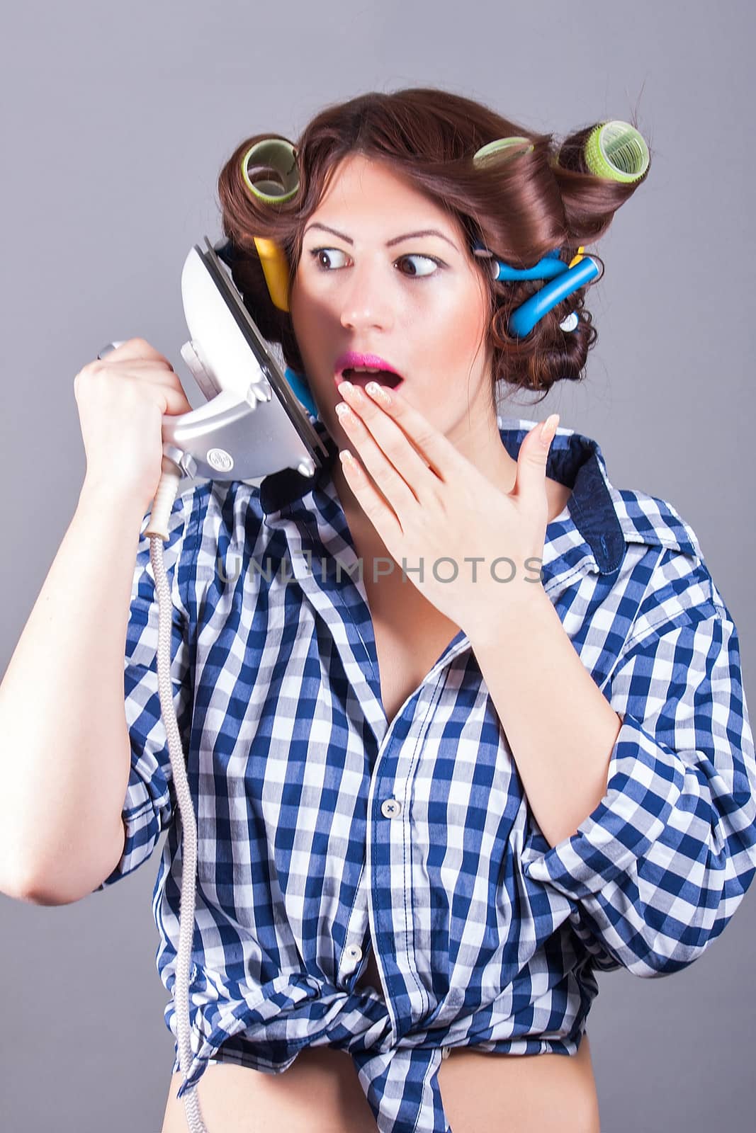 portrait of sexy housewife with iron like cell phone
