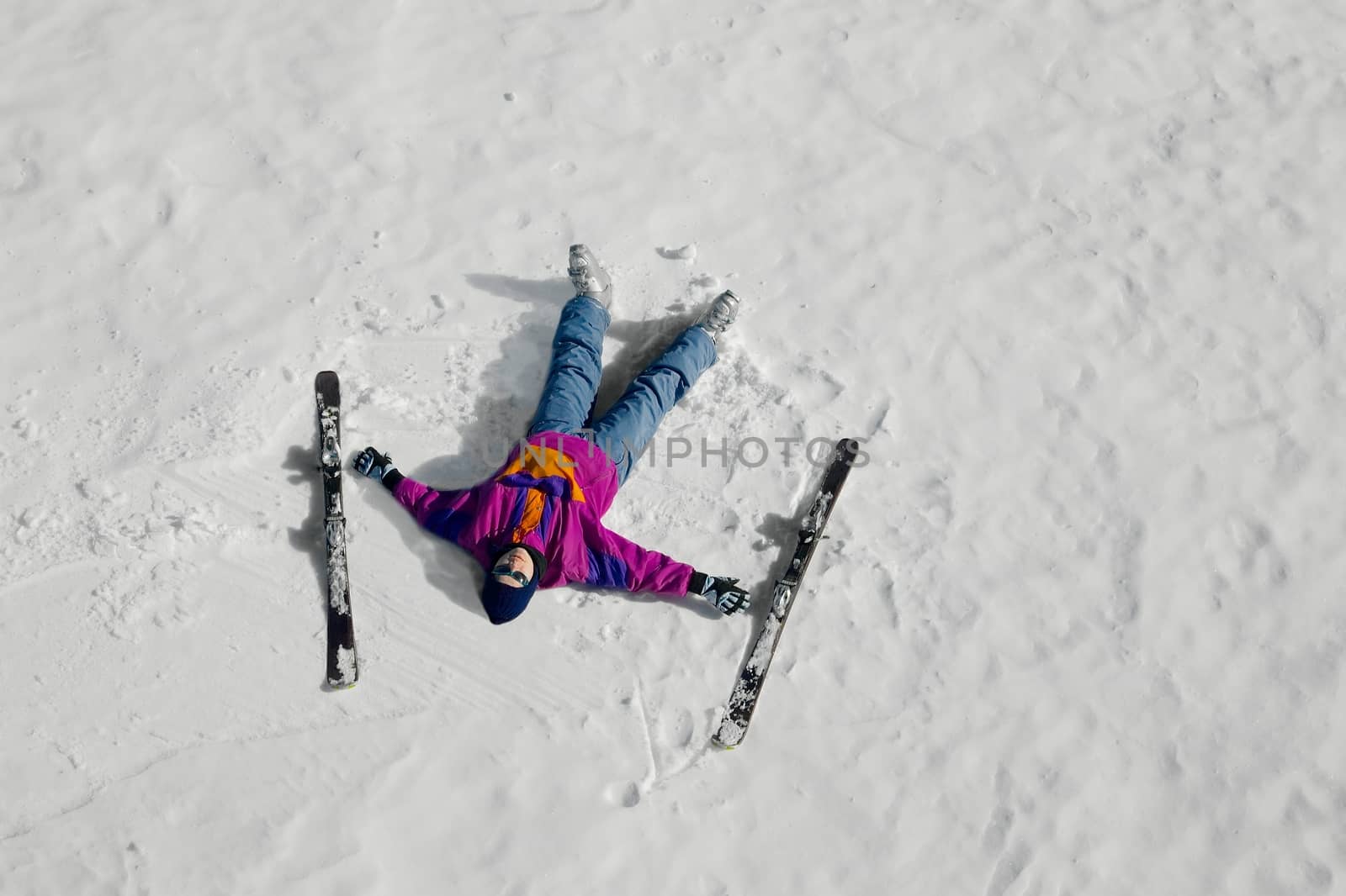 Female skier laying on the snow