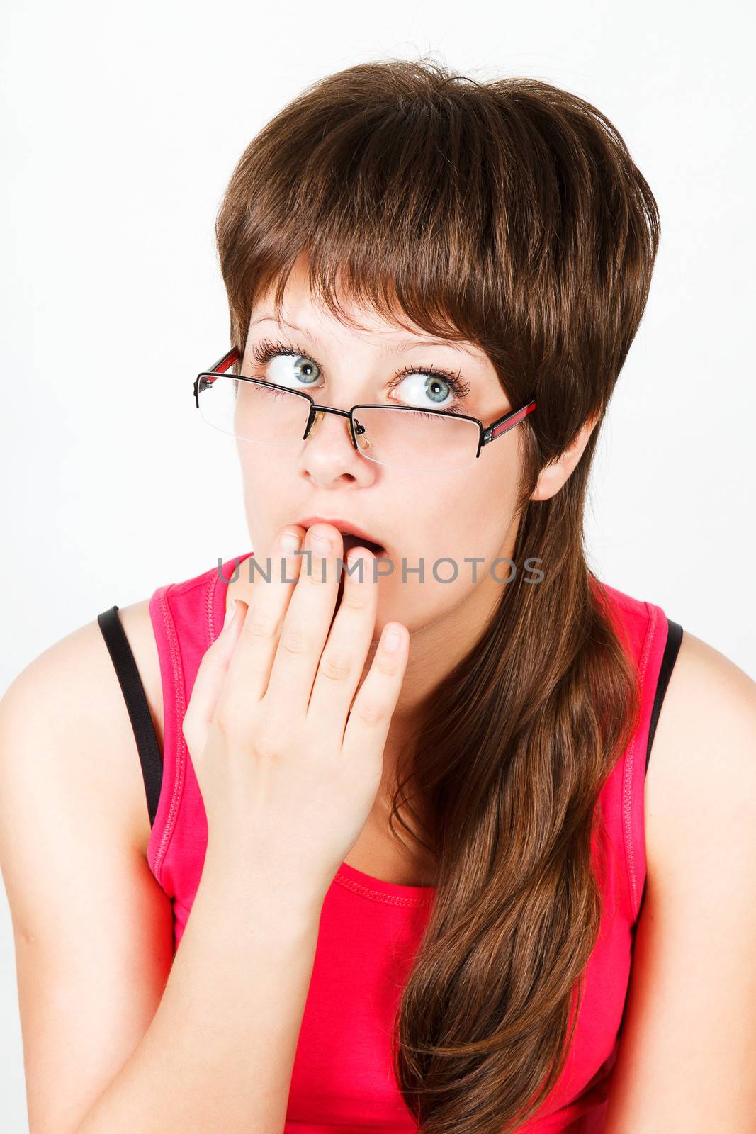 Young attractive girl with glasses surprised. portrait
