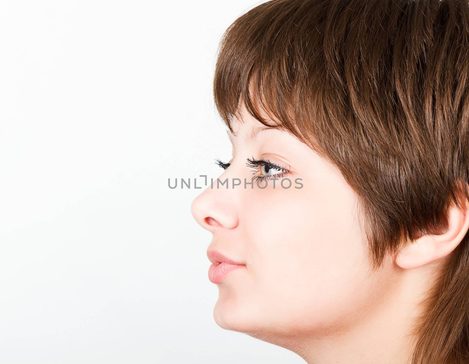 Young attractive girl kisses the. Portrait in profile