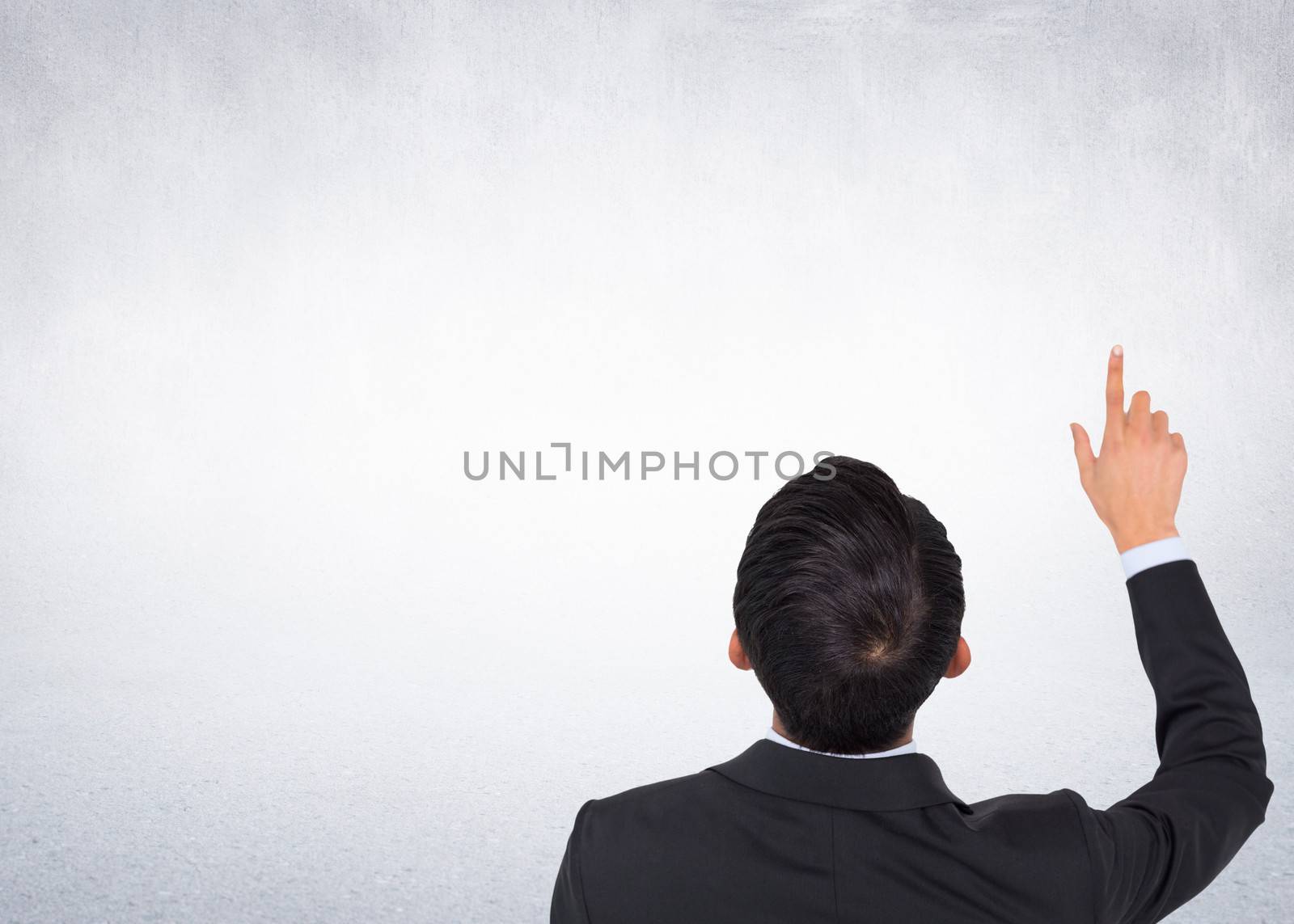 Composite image of asian businessman pointing by Wavebreakmedia