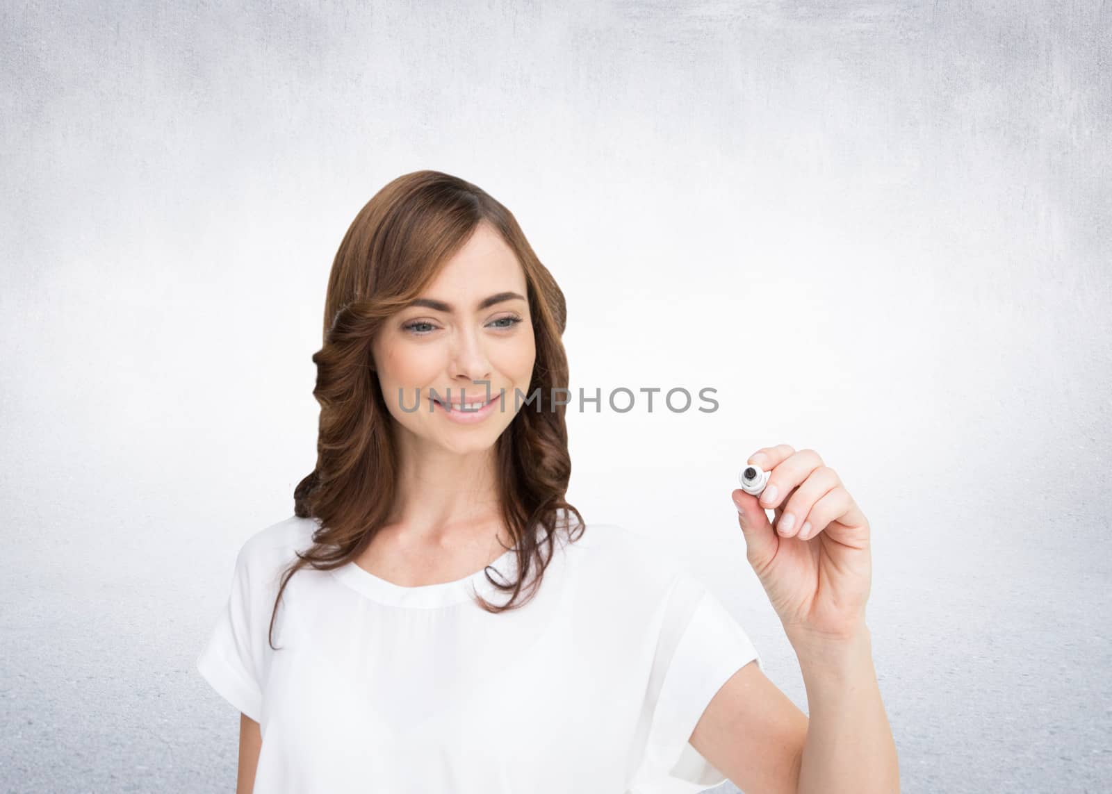 Composite image of smiling businesswoman holding marker