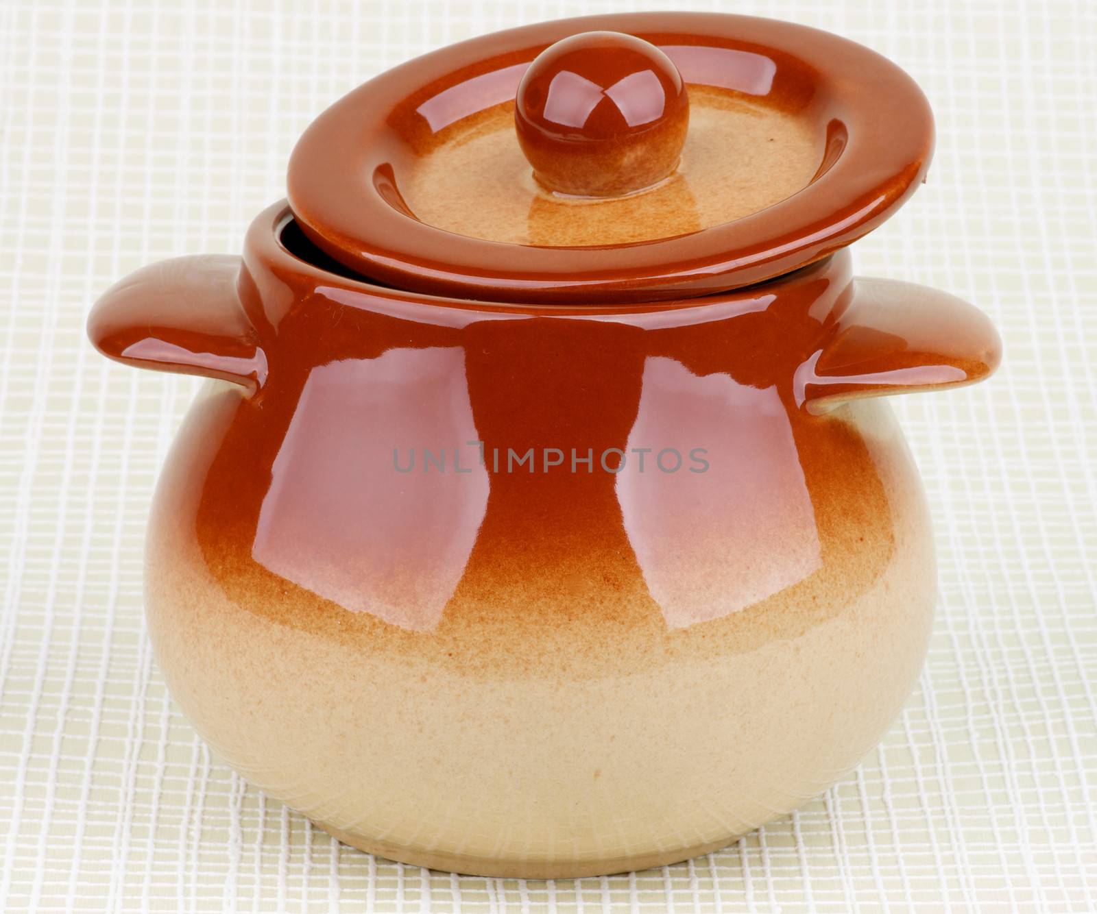 Brownish Stoneware Pot with Lid isolated on Light Green Checkered background