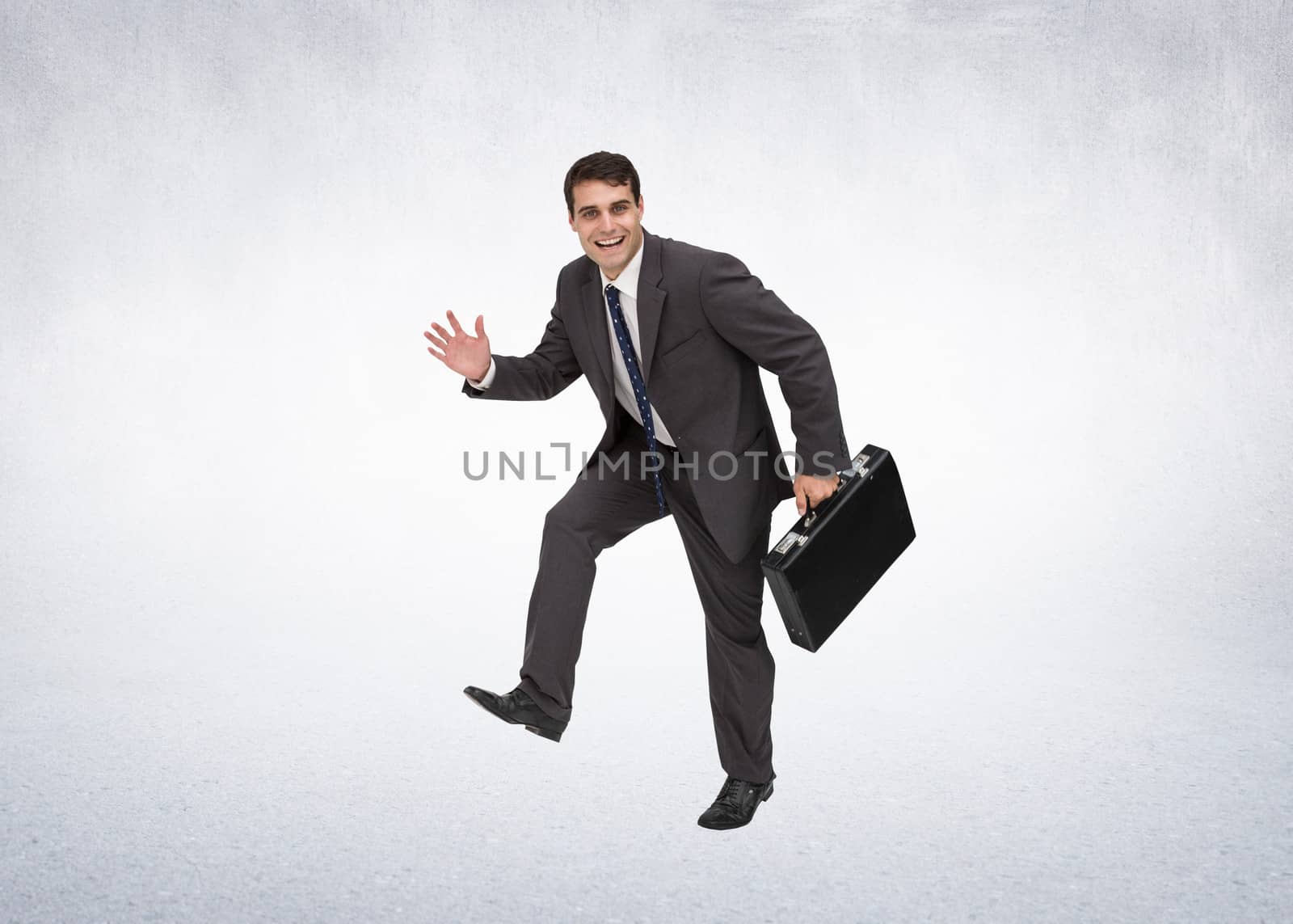 Composite image of cheerful businessman in a hury by Wavebreakmedia