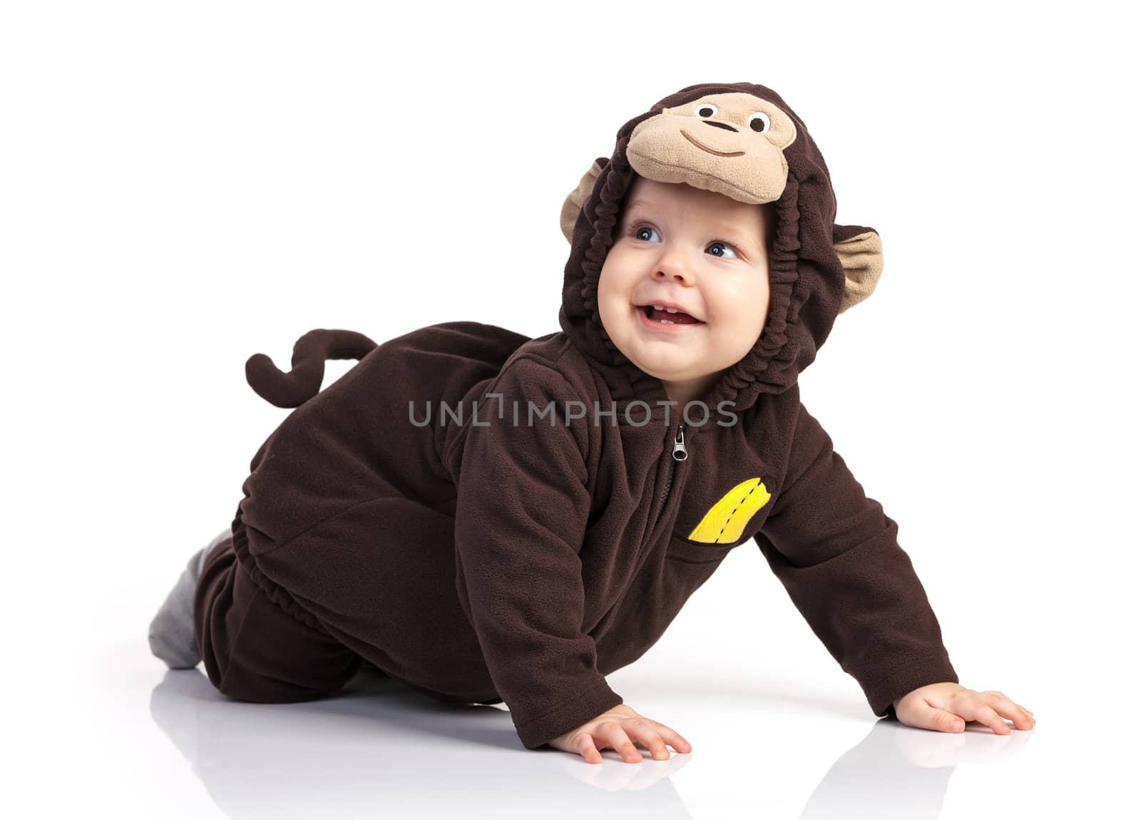 Cute baby boy in monkey costume looking up over white background