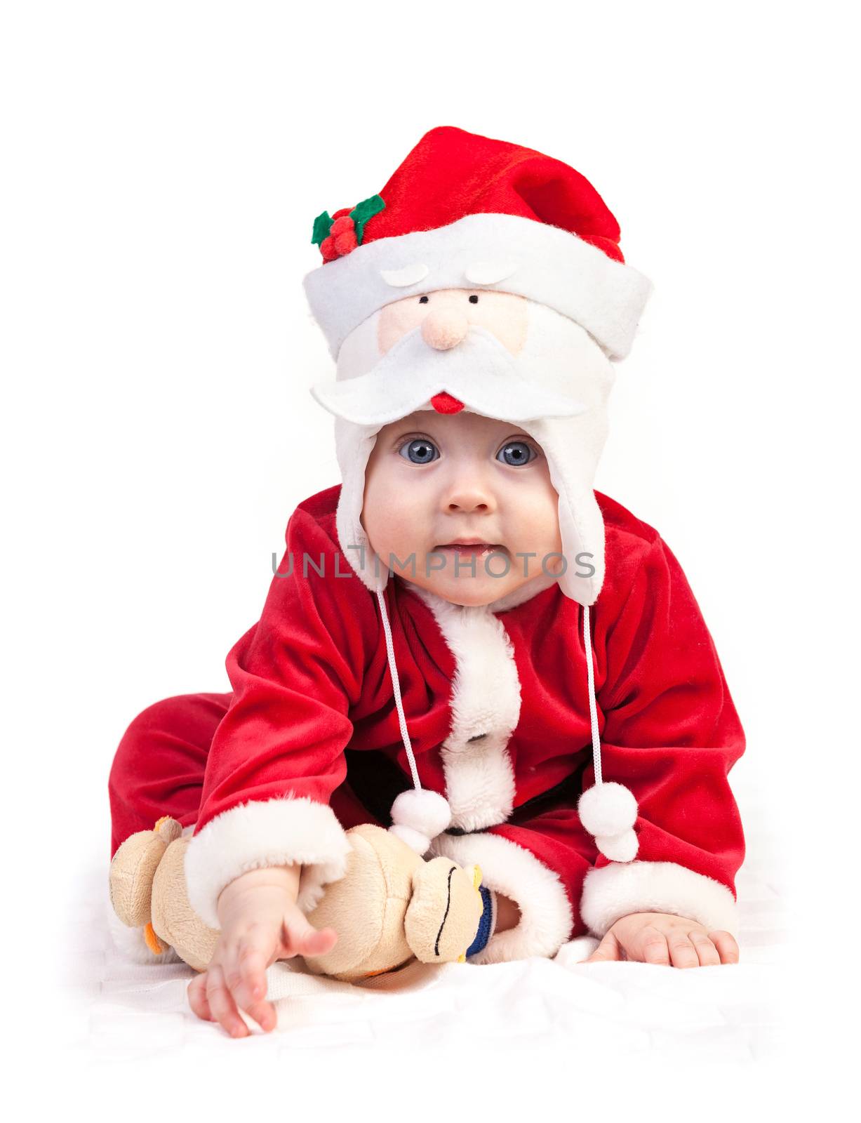 Cute little boy in Santa costume over white background