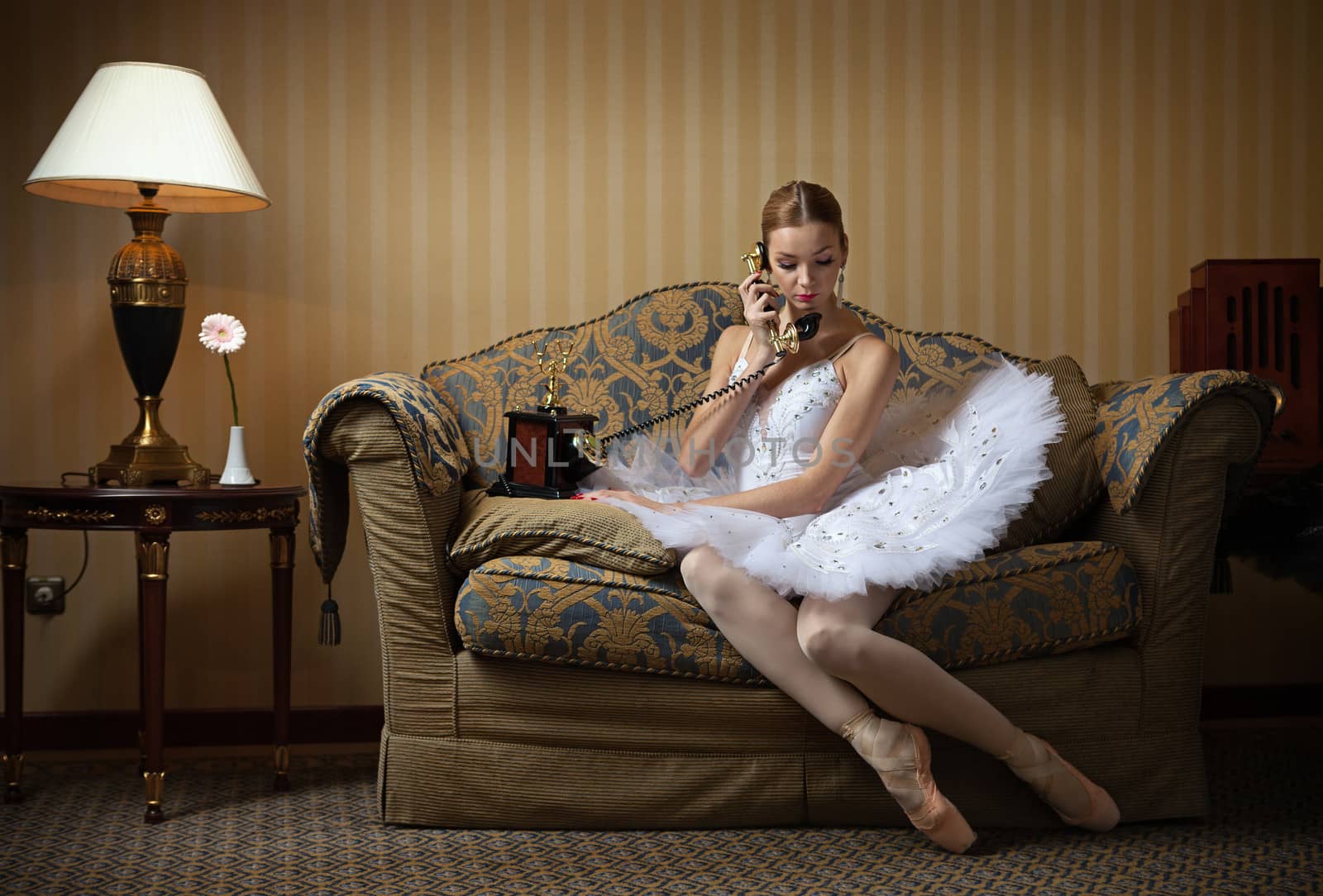 Professional ballet dancer talking on the phone by photobac