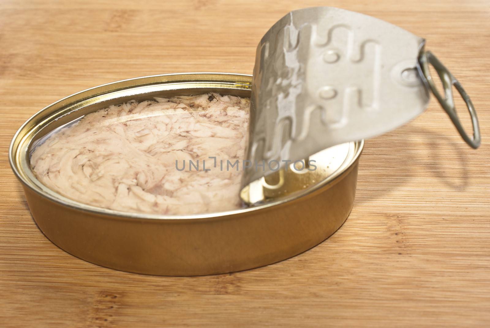 Can of Tuna isolated on a wooden kitchen bench