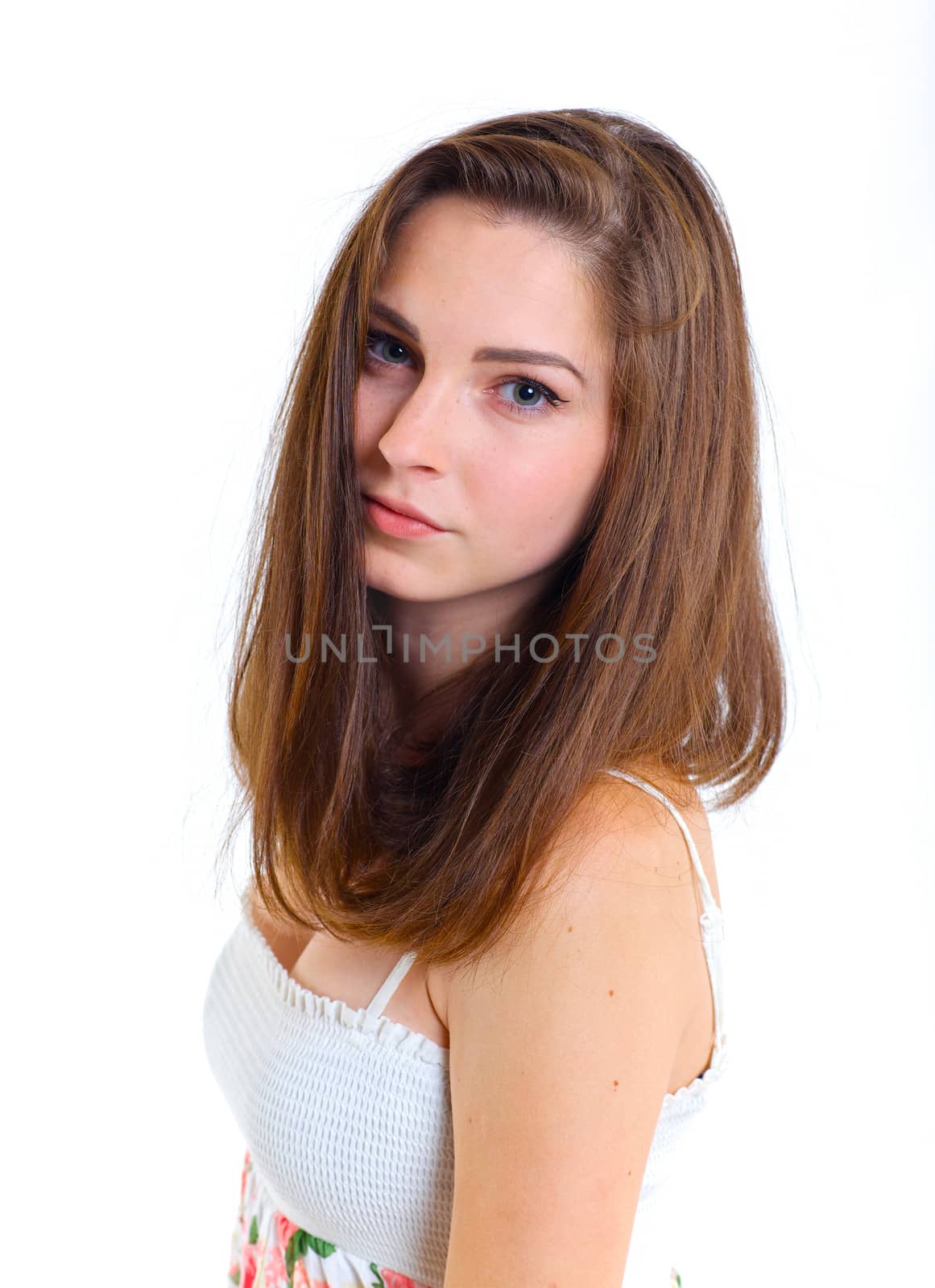 Portrait of teenage girl in a white dress. Isolated over white background.