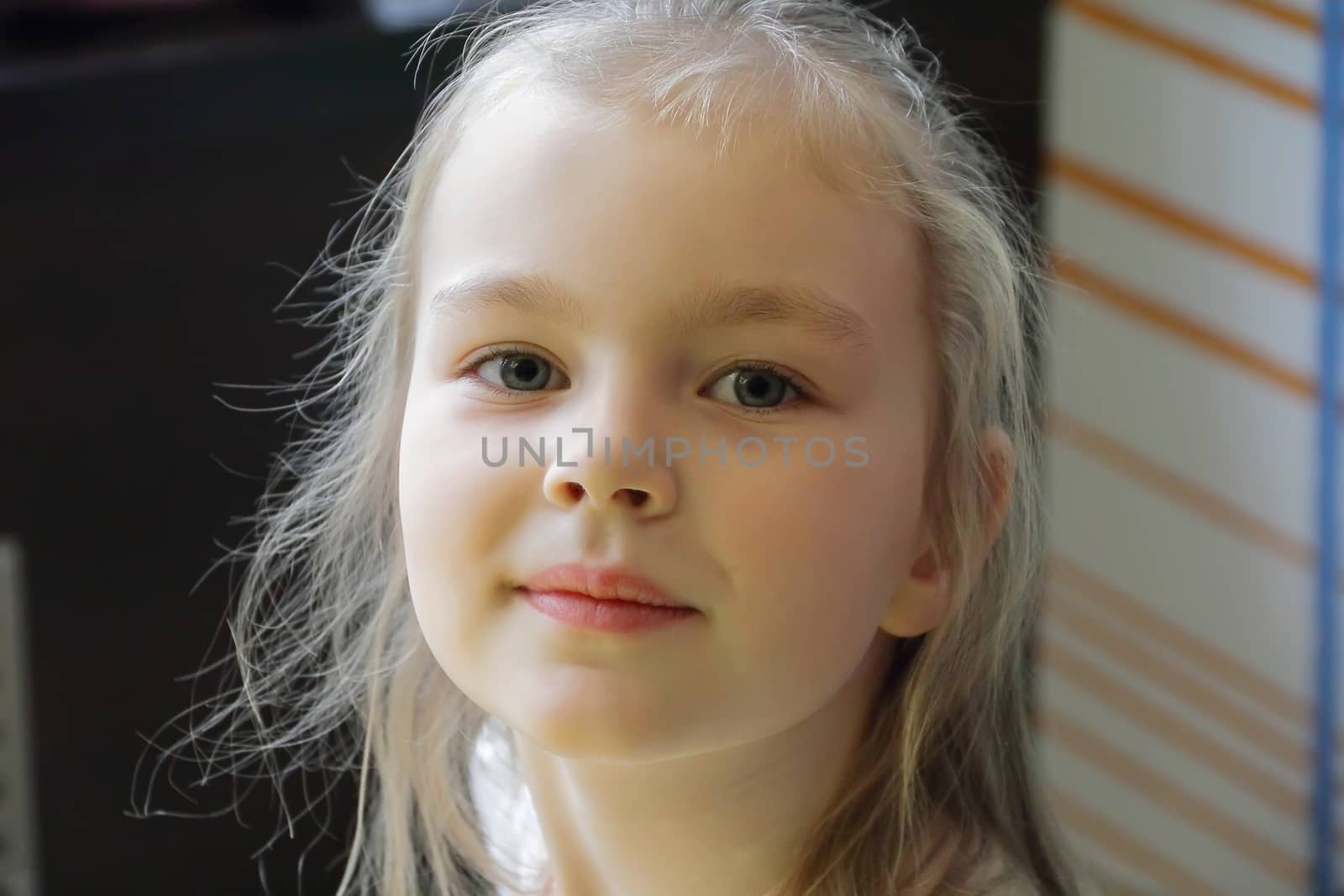 Portrait of beautiful girl with blond hair and blue eyes