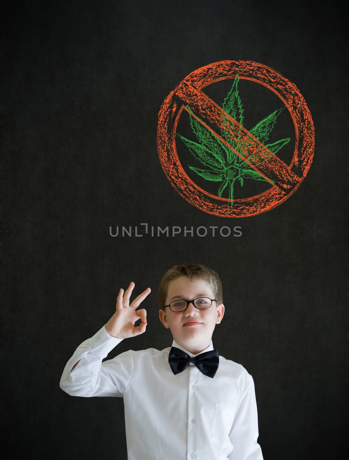 All ok or okay sign boy dressed up as business man with no weed marijuana on blackboard background