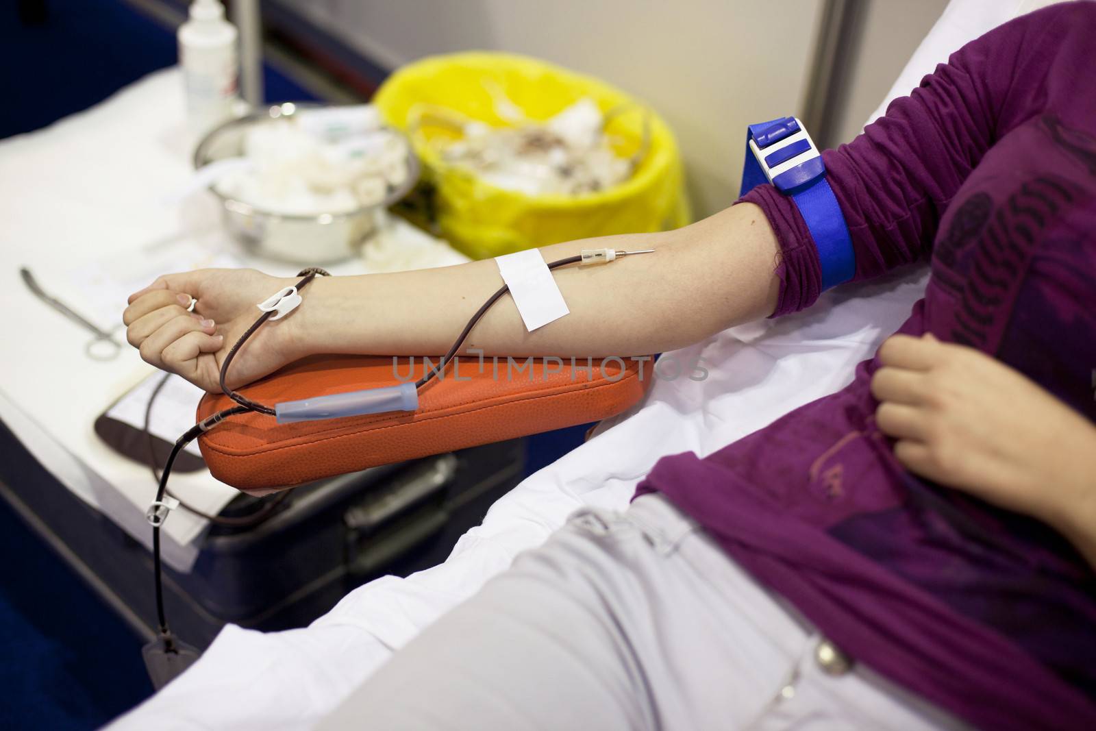 Blood donor's arm up close while giving blood