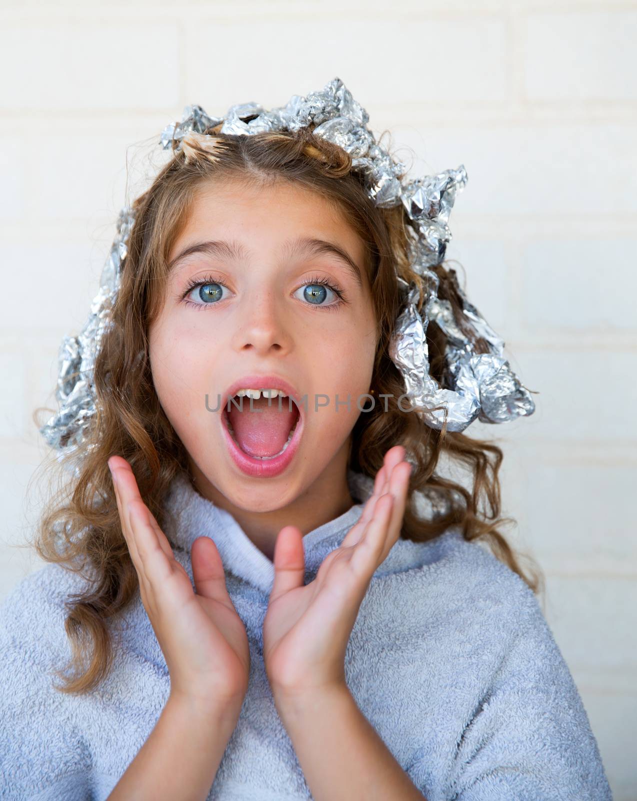 Funny kid girl surprised with his dye hair with foil blue eyes