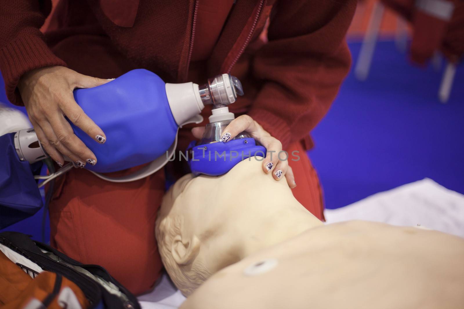 Paramedic demonstrates CPR on dummy
