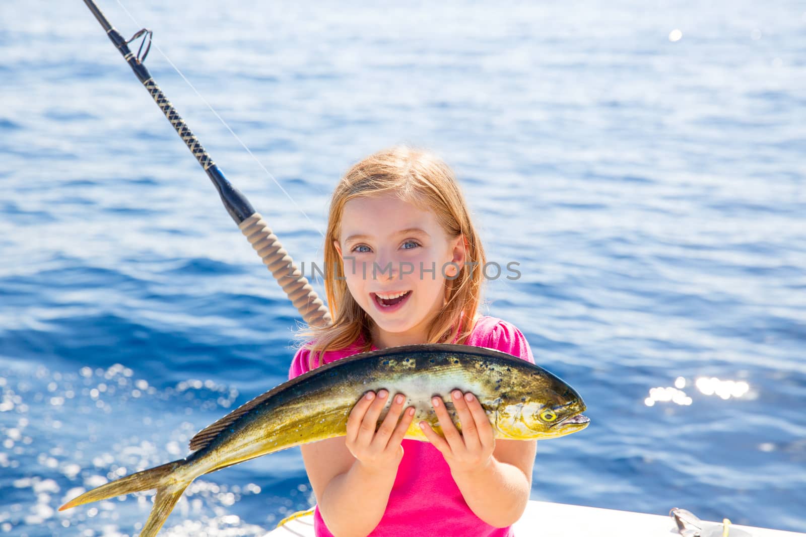 Blond kid girl fishing Dorado Mahi-mahi fish happy catch by lunamarina