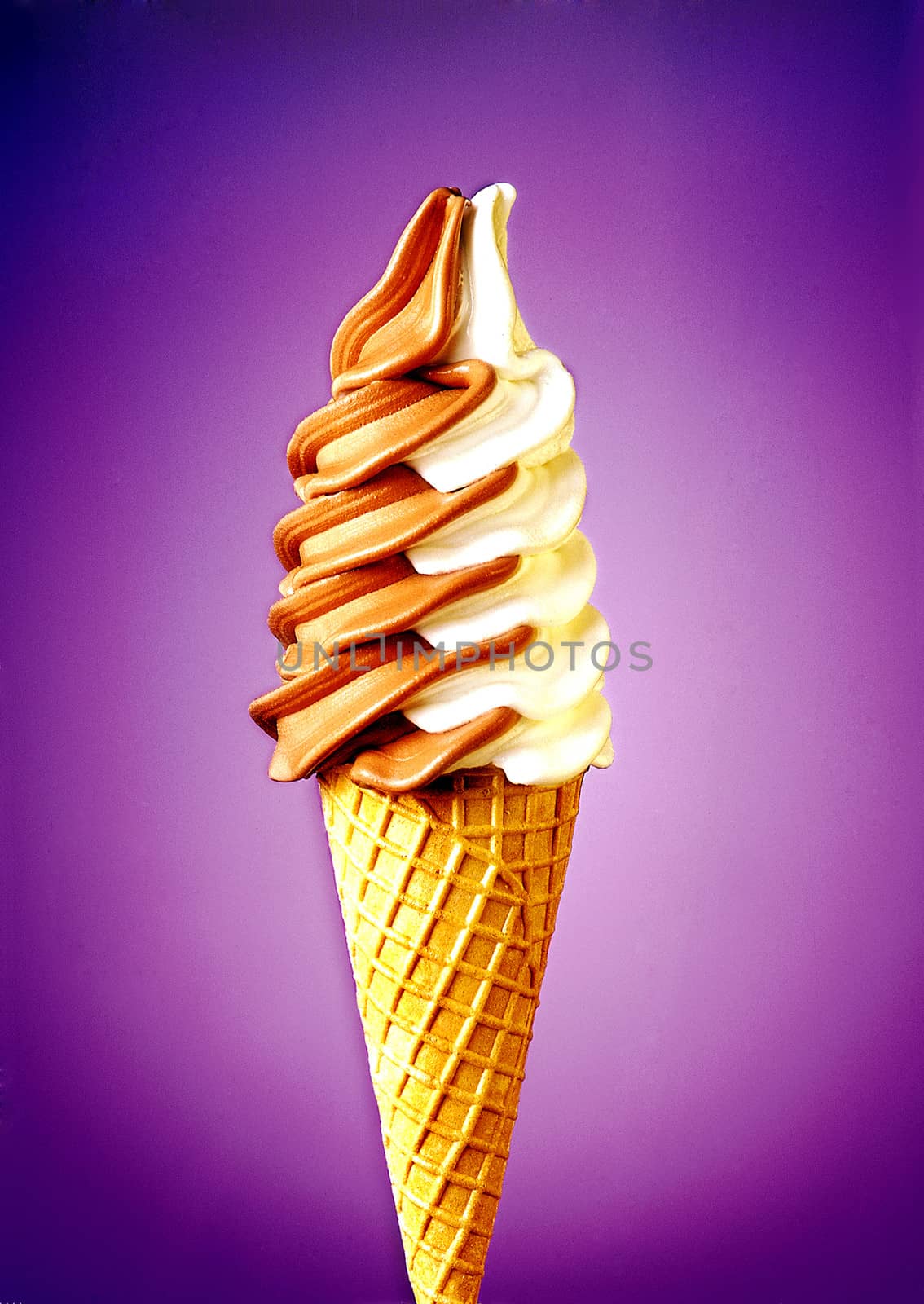 Mixed vanilla and chocolate flavour ice cream cone on gradient background.