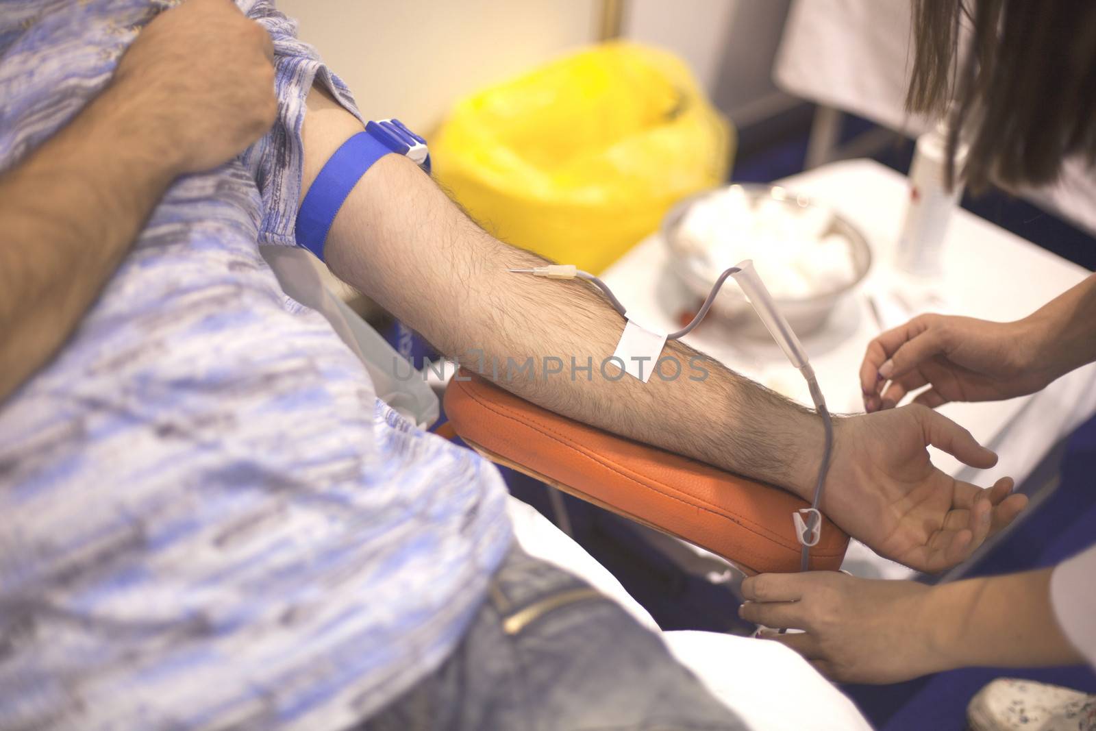 Blood donor's arm up close while giving blood
