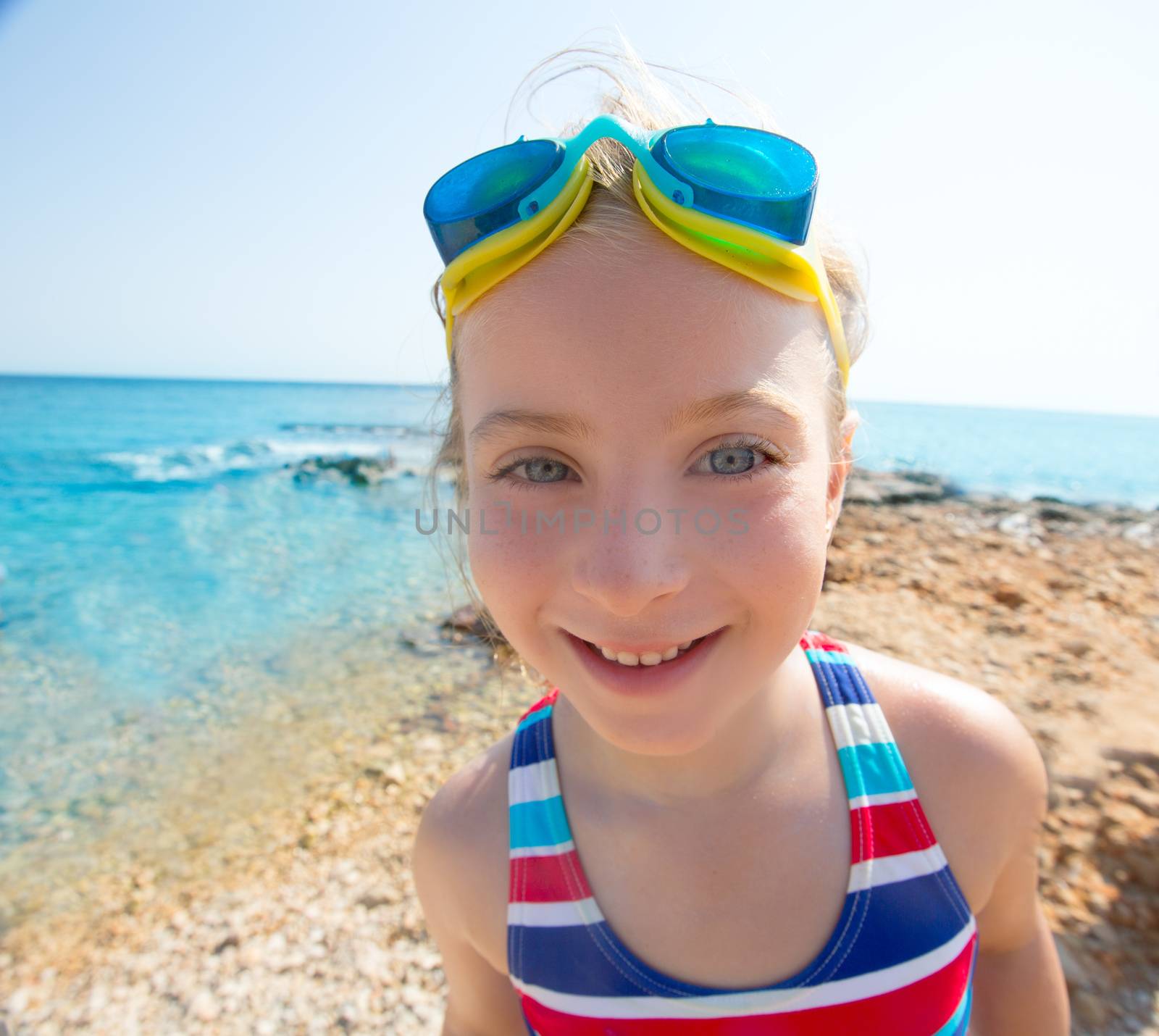 Kid funny girl wide angle beach portrait swimsuit and goggles by lunamarina