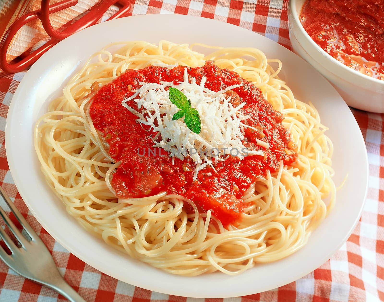 Spaghetti served with tomato sauce and cheese.