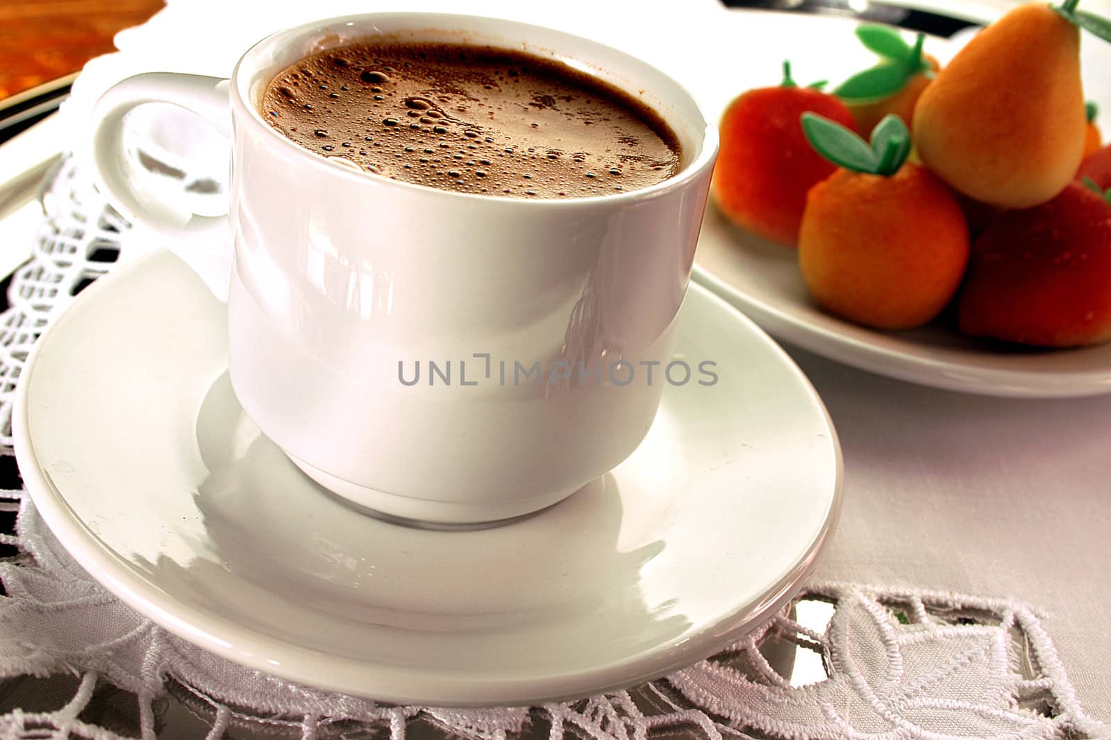 Traditional serving of turkish coffee with marzipan aside.