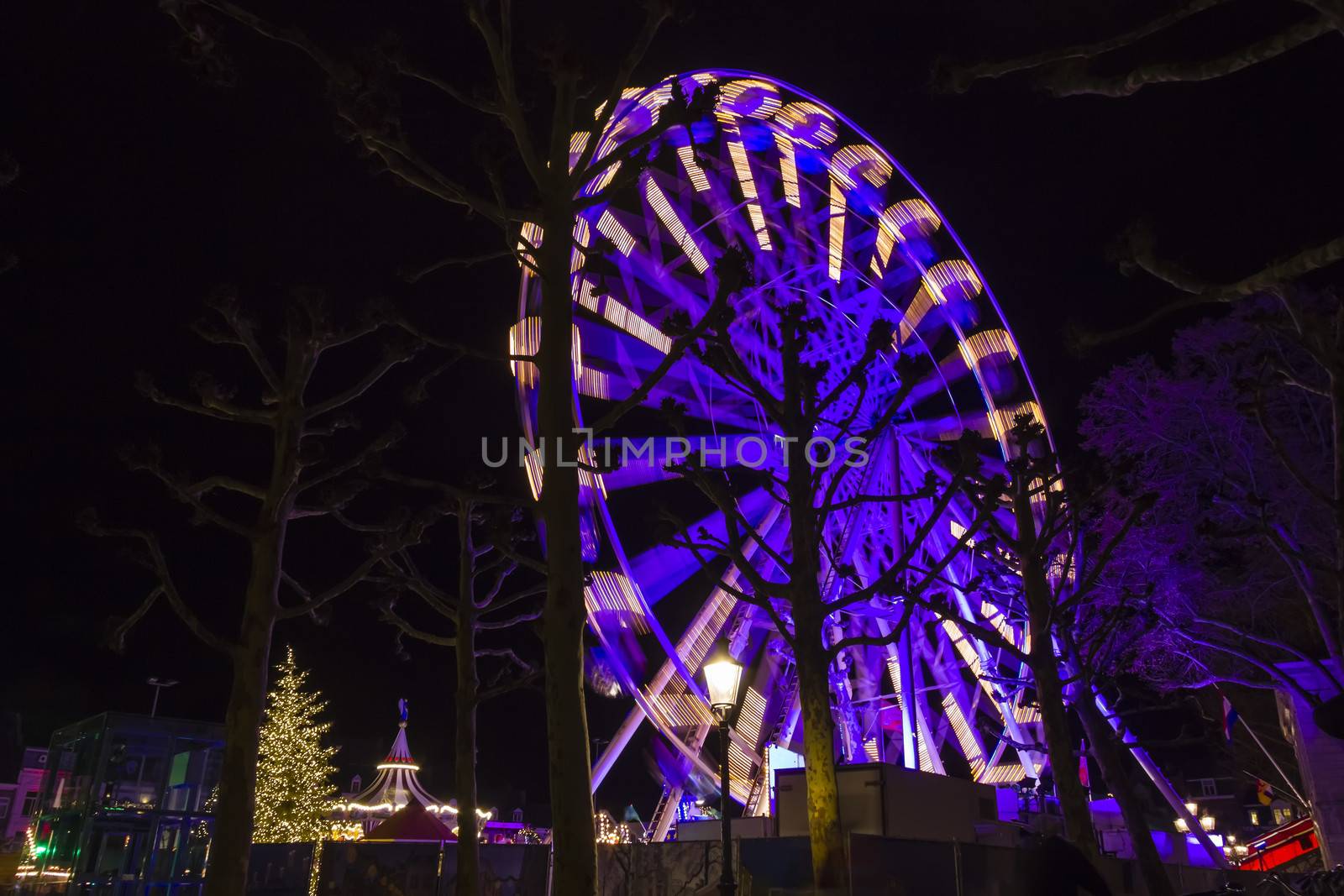 Turning Ferris wheel on a christmas market, Maastricht, the Netherlands by Tetyana