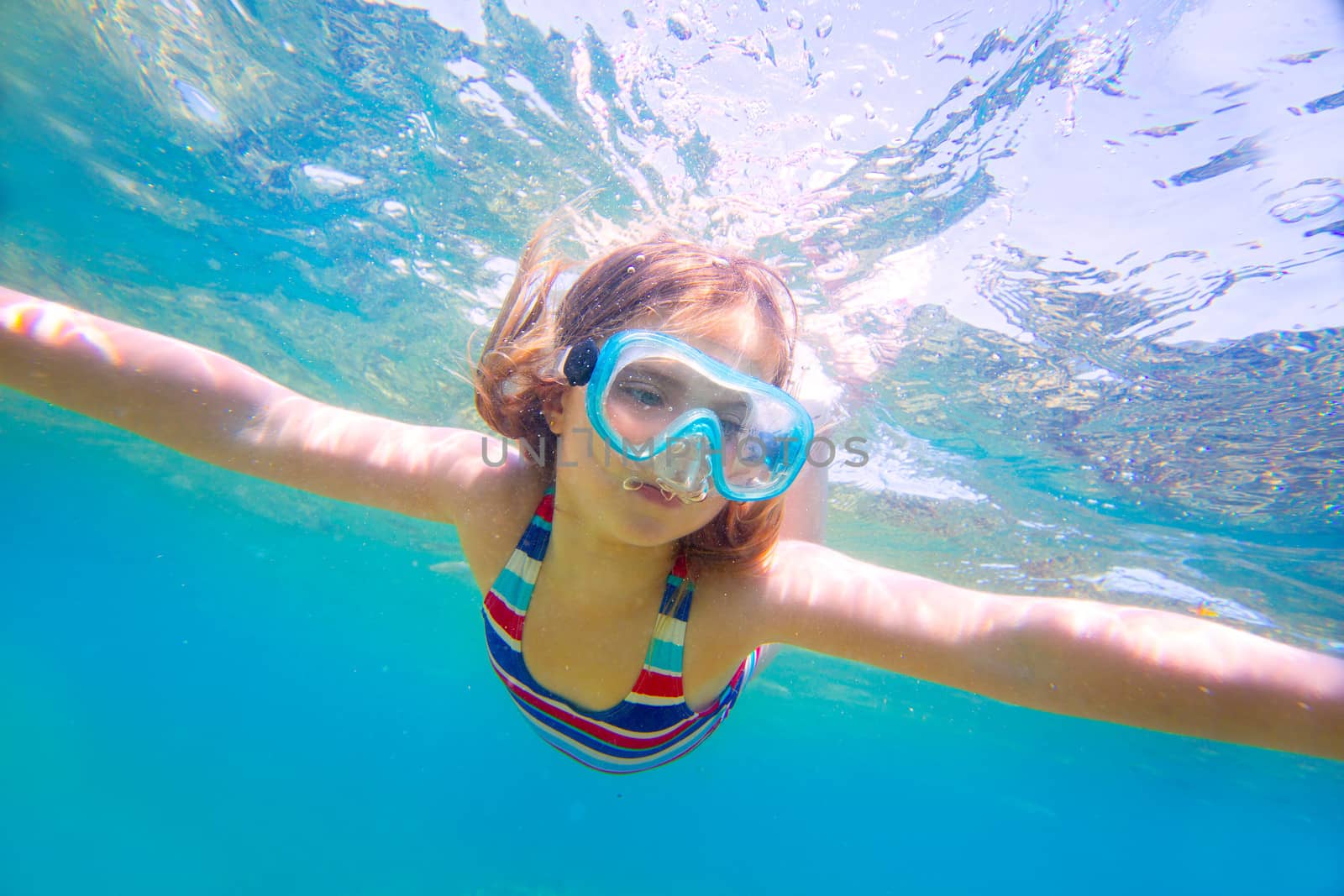 snorkeling blond kid girl underwater goggles and swimsuit by lunamarina