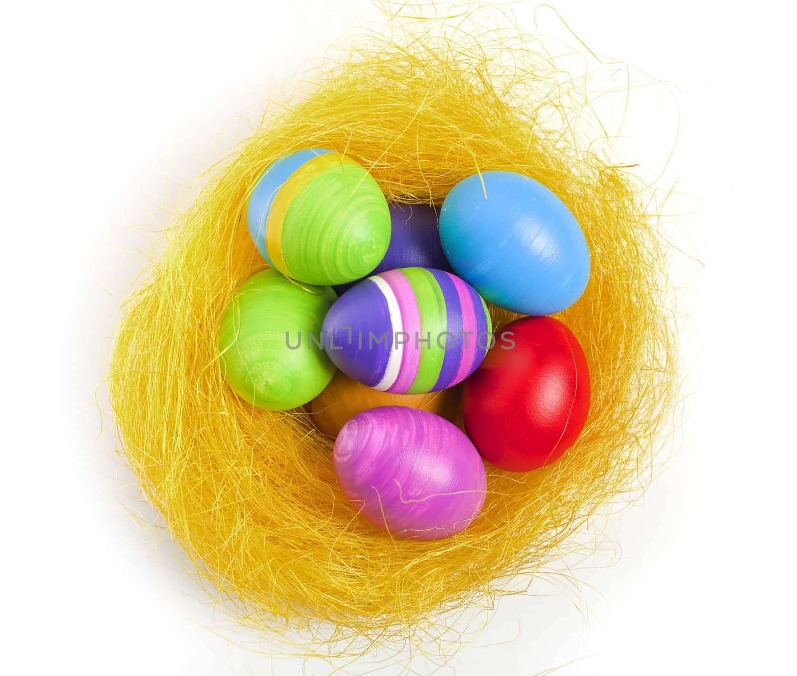 Hand coloured easter eggs in the yellow nest