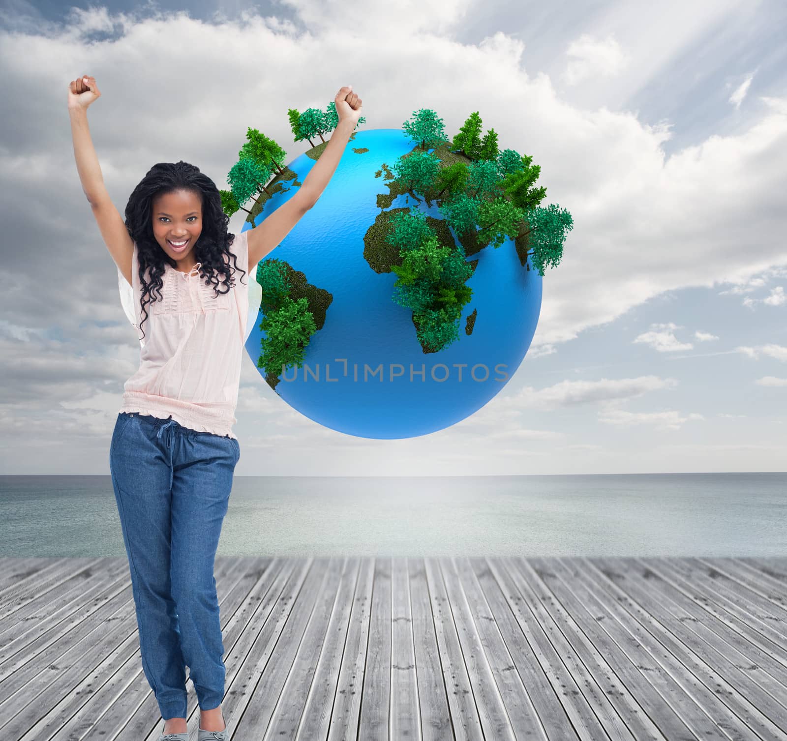 Composite image of a happy young woman is standing with her hands in the air 