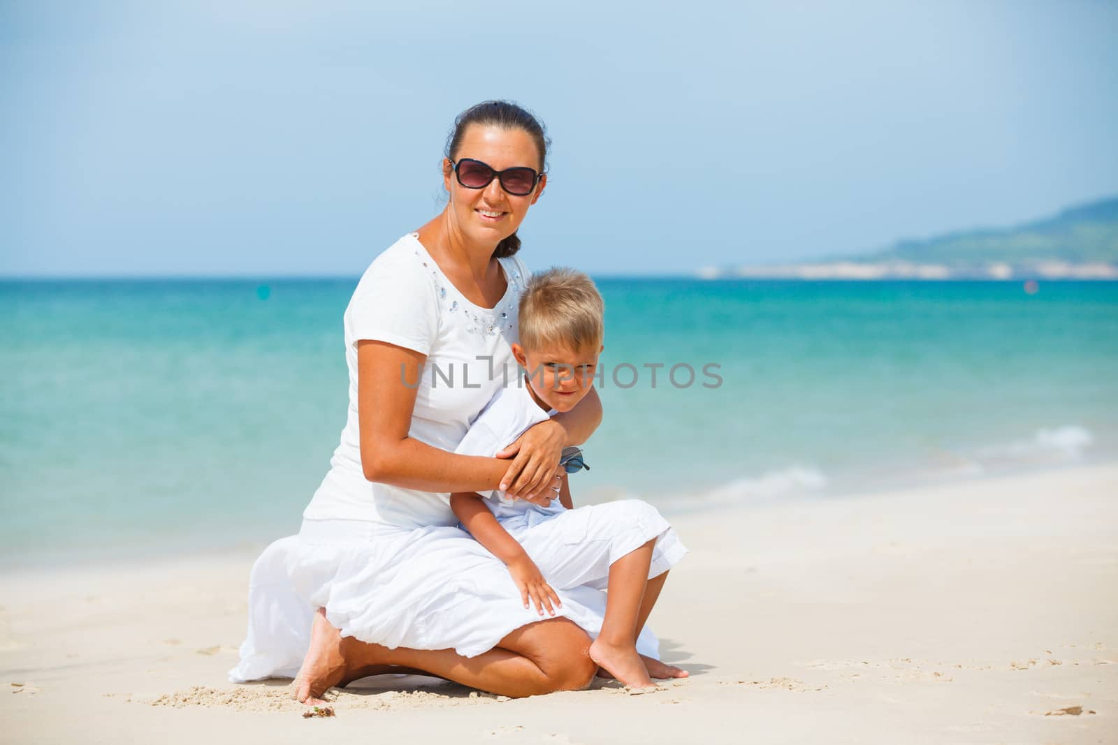 Mother and son having fun on tropical beach