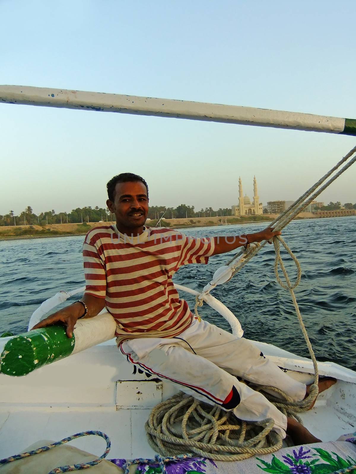 Captain driving felucca boat, Aswan, Egypt