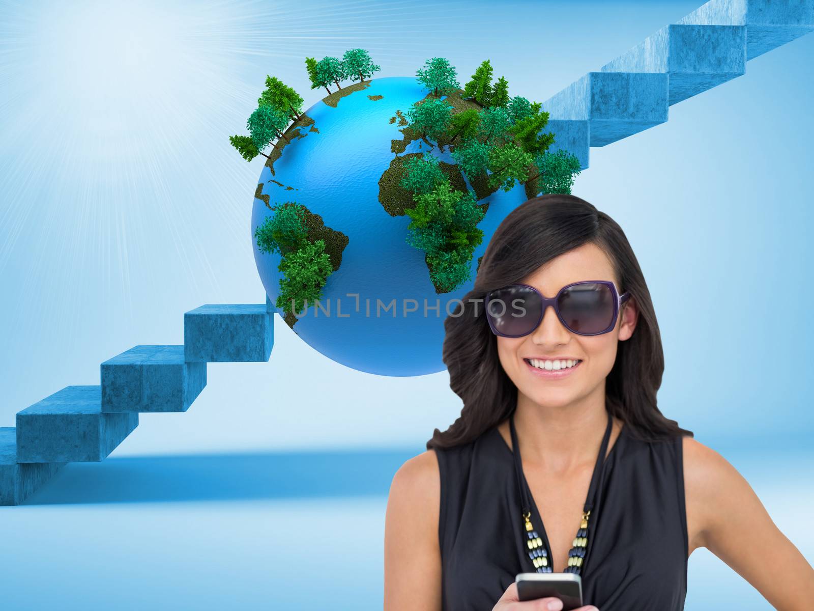 Composite image of happy brunette holding smartphone by Wavebreakmedia