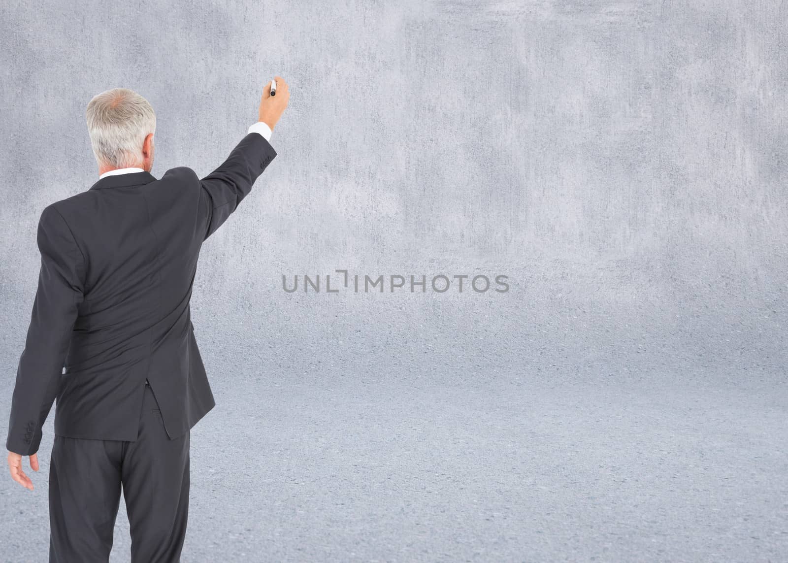 Composite image of rear view of serious businessman standing and writing by Wavebreakmedia