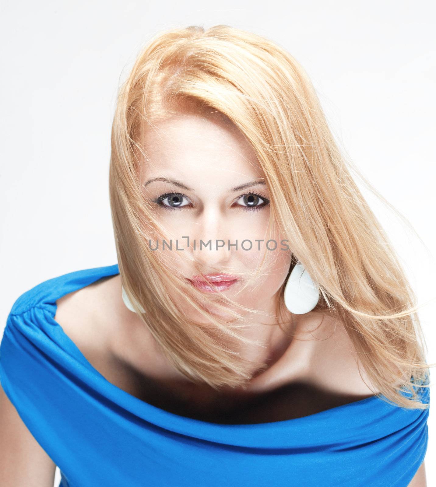 portrait of a young beautiful blond woman - isolated on light gray