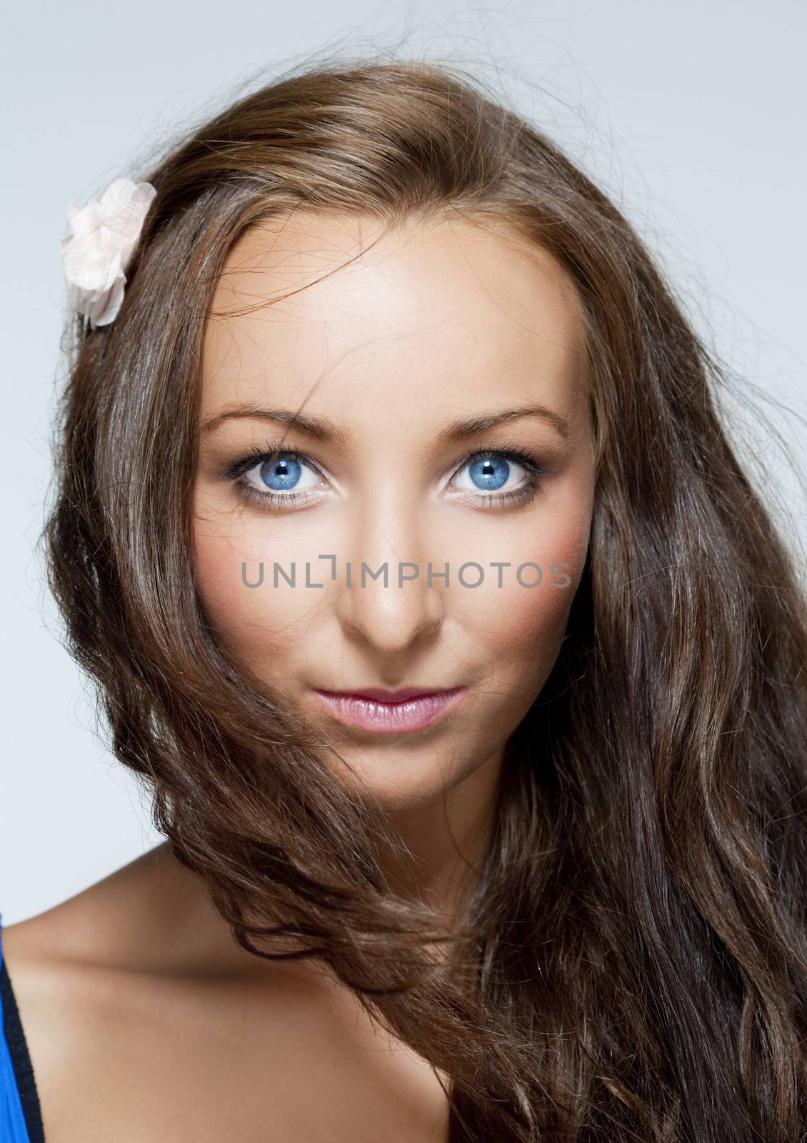portrait of a young beautiful woman with brown hair and blue eyes