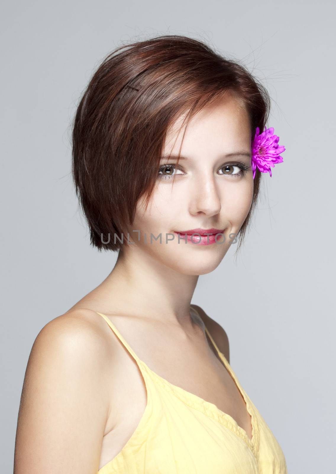 portrait of a beautiful teenage girl in yellow dress - isolated on gray