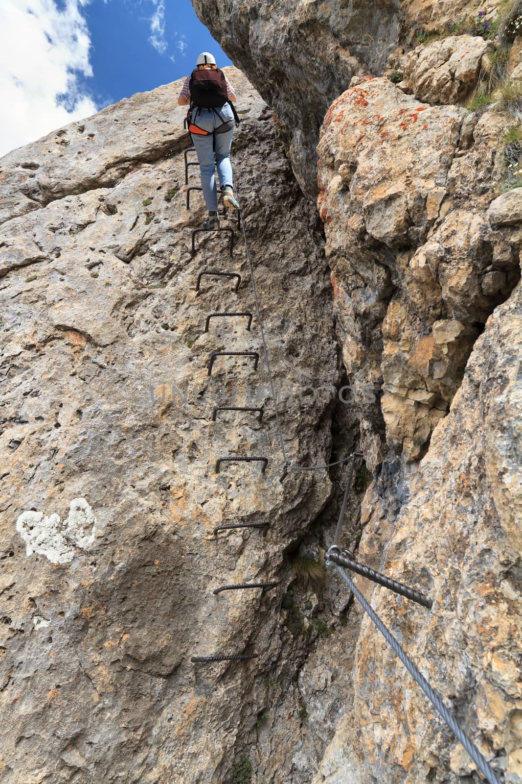 female climber on Col Rodella via ferrata, italian Dolomites