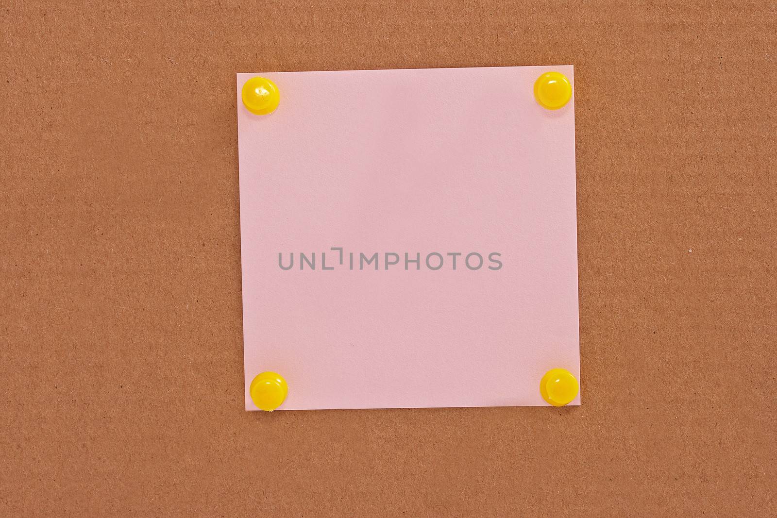 Pink note paper attached with yellow pins