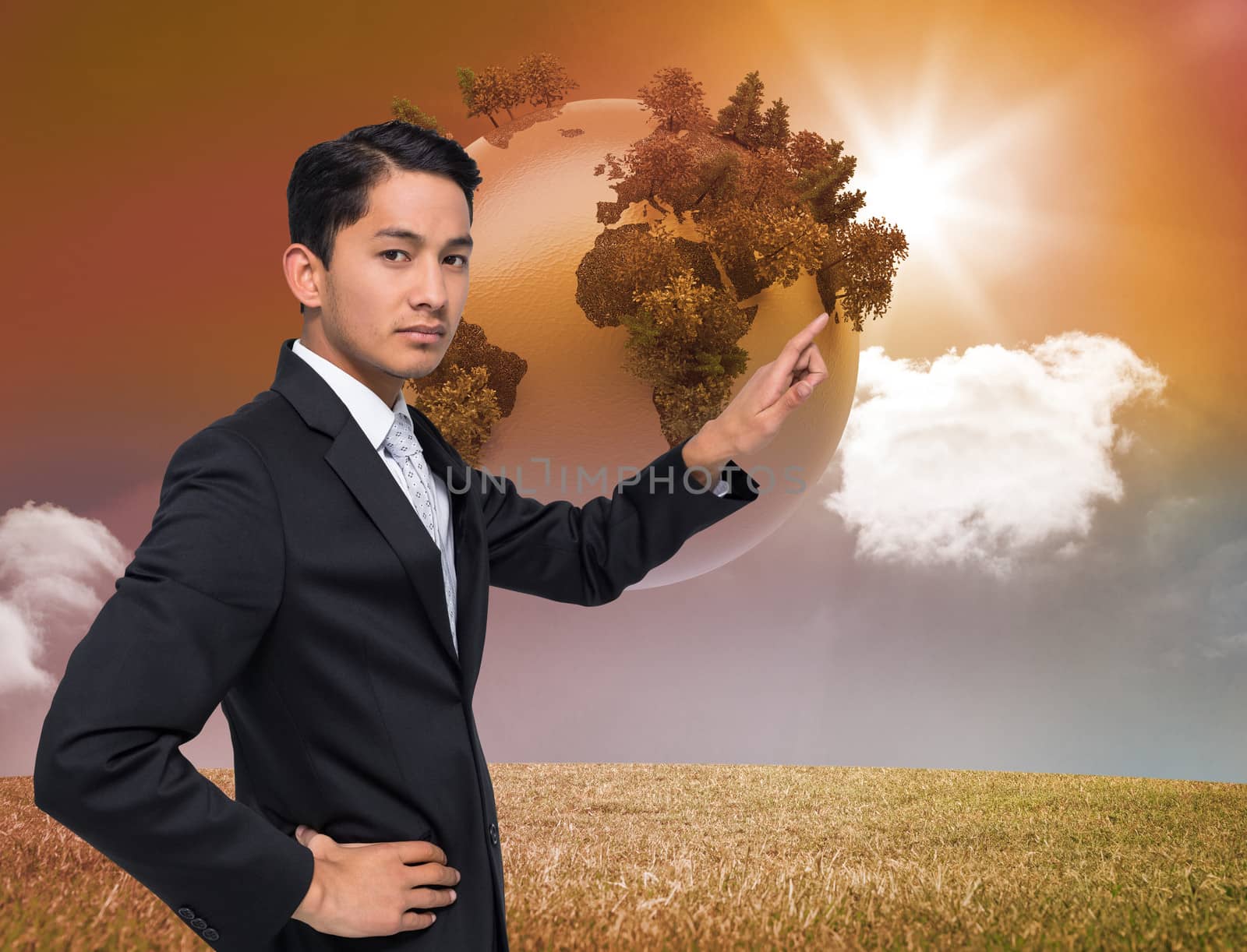 Composite image of unsmiling asian businessman pointing by Wavebreakmedia